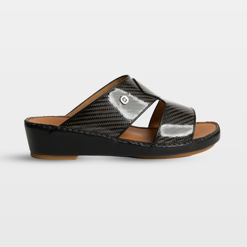 Black sandal with a metallic finish on a light gray background