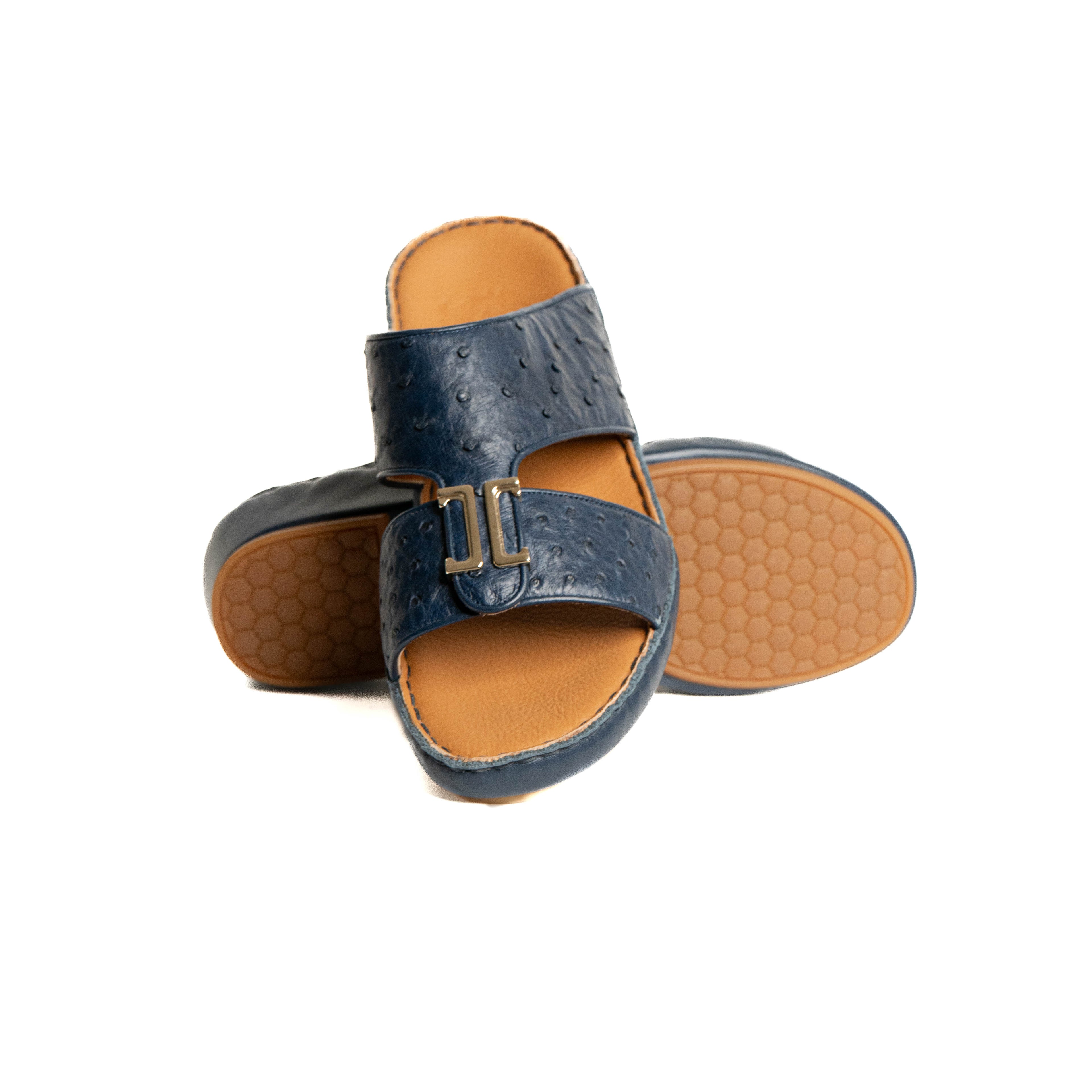 Pair of blue sandals with brown soles on a white background