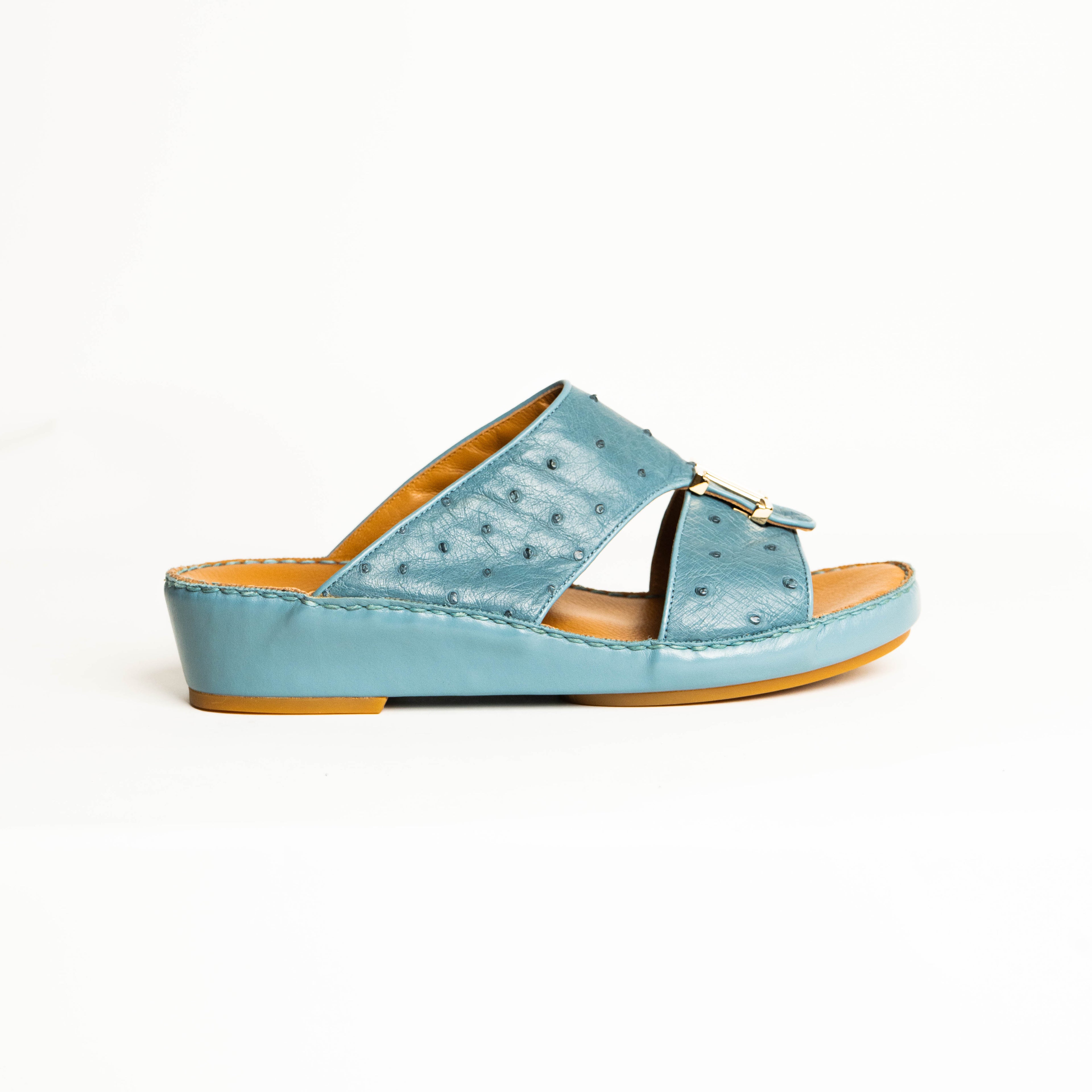 Light blue sandal with a brown sole on a white background
