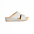 White sandal with brown sole on a white background