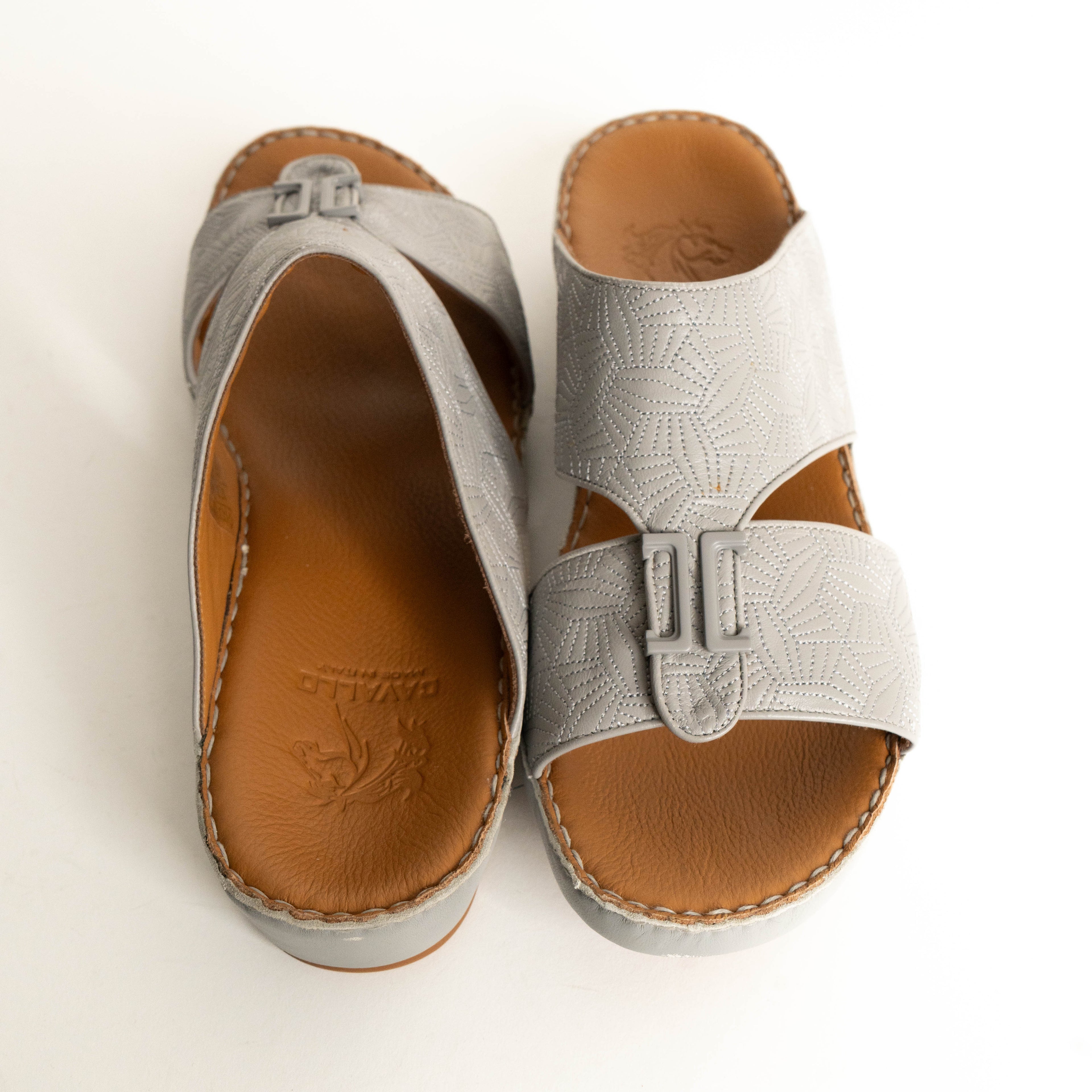 Pair of gray sandals with brown soles on a white background