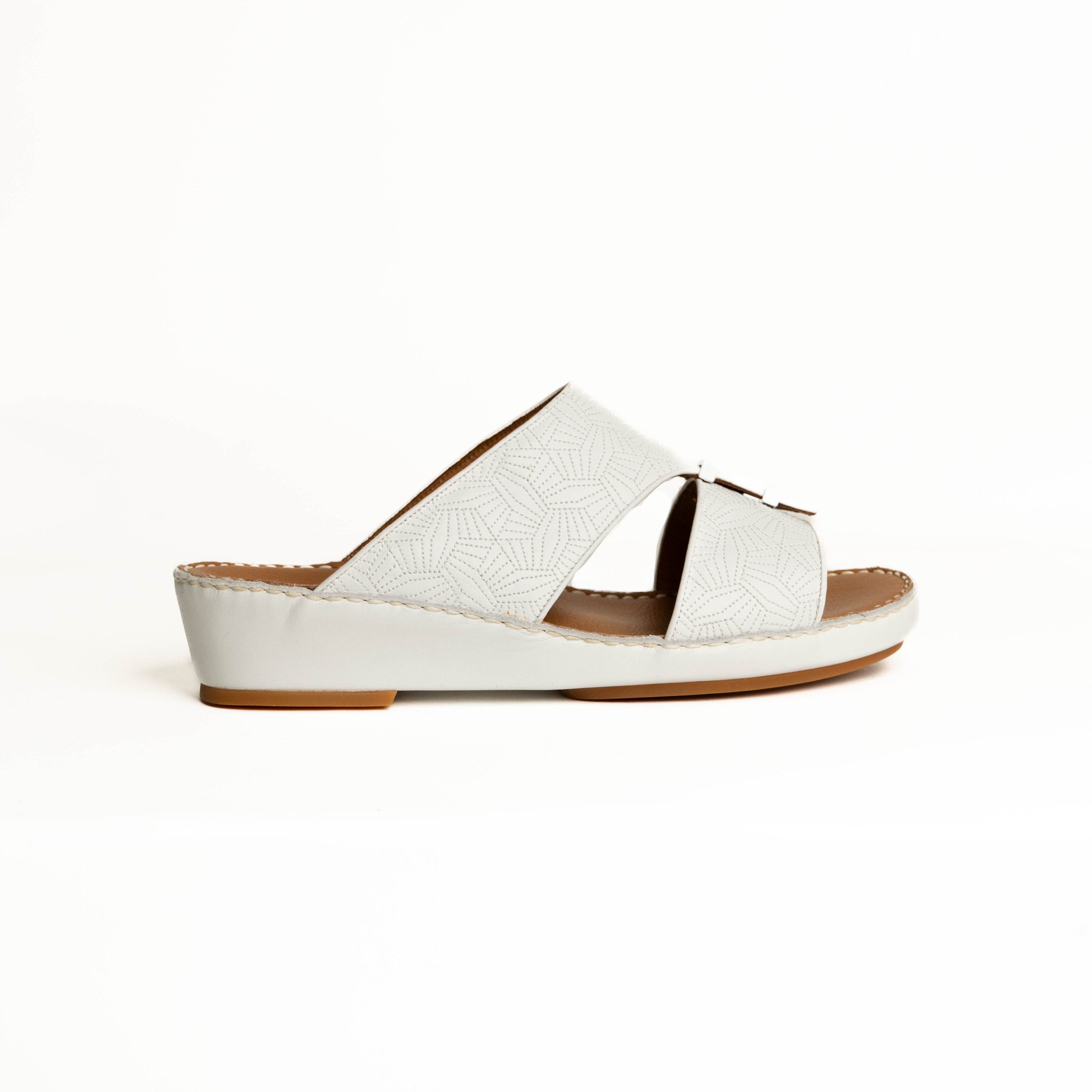 White sandal with brown sole on a white background