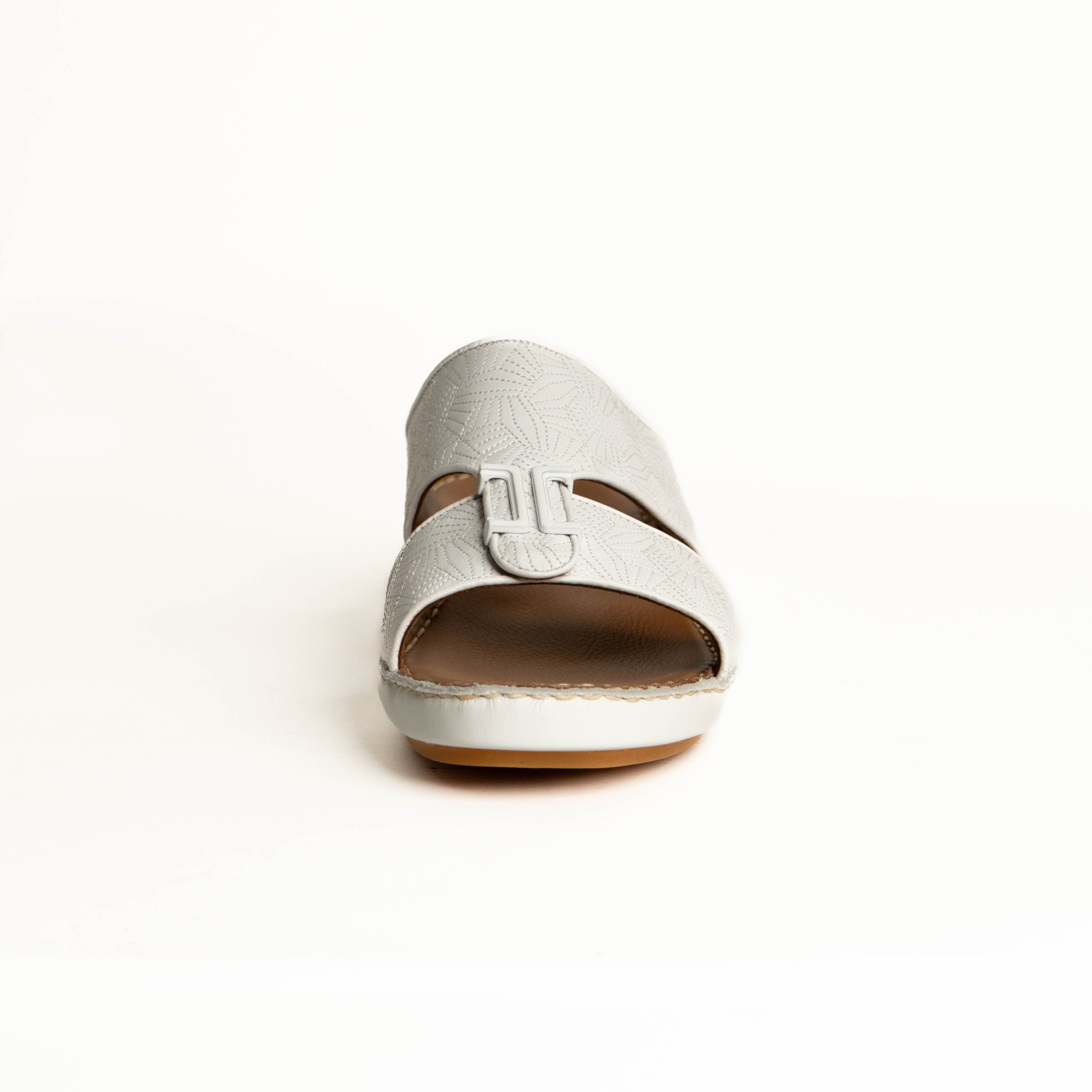 White sandal with a brown sole on a white background