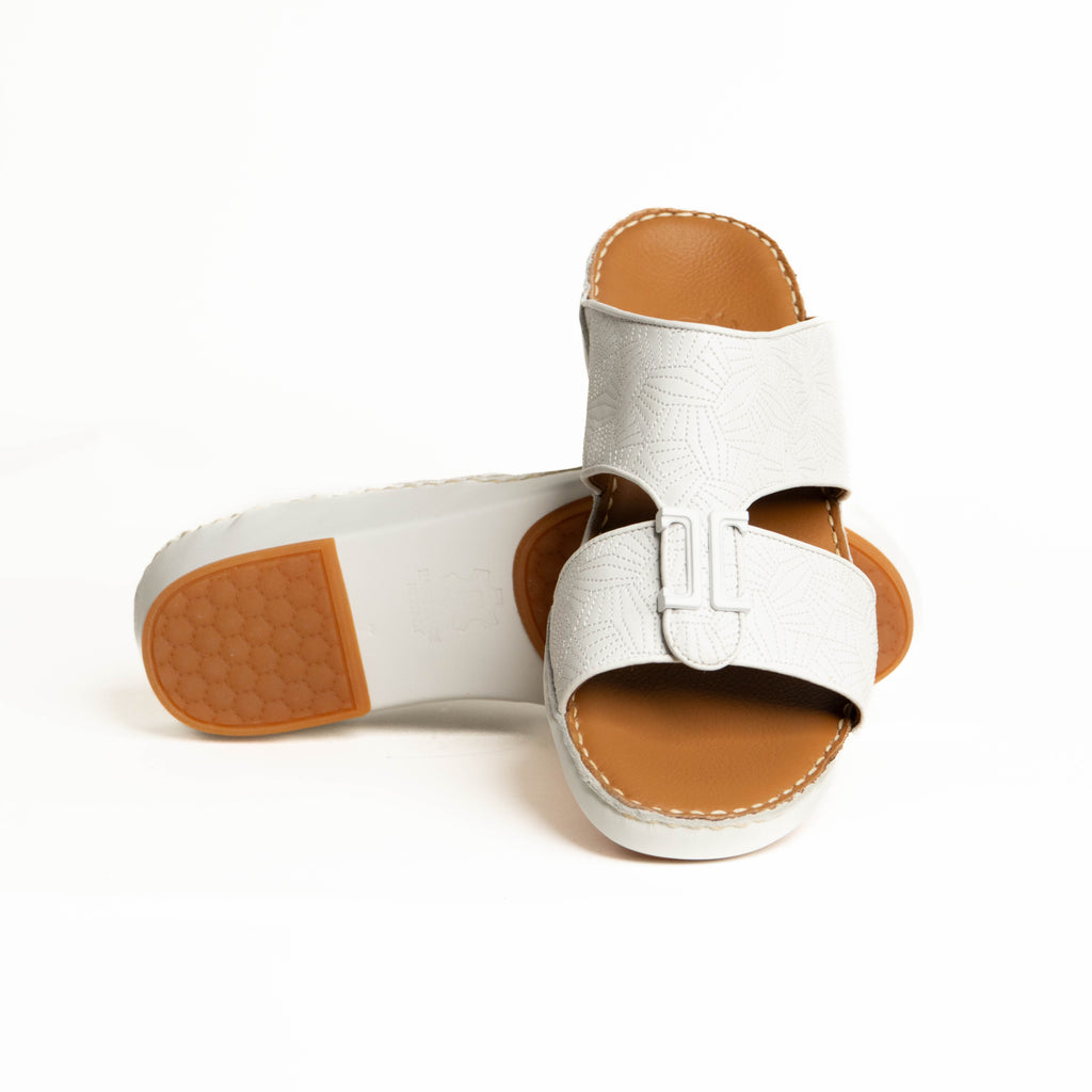 White sandals with brown soles on a white background