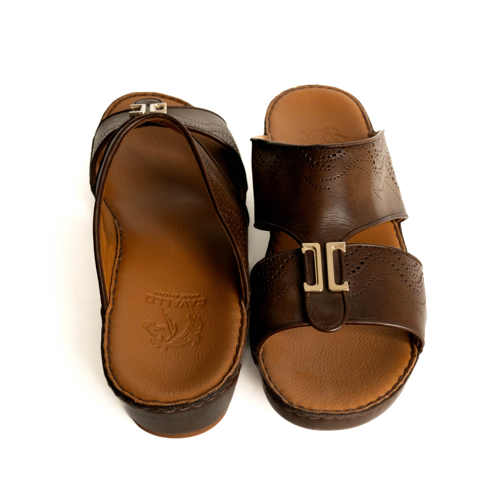 Pair of brown sandals with a gold buckle on a white background