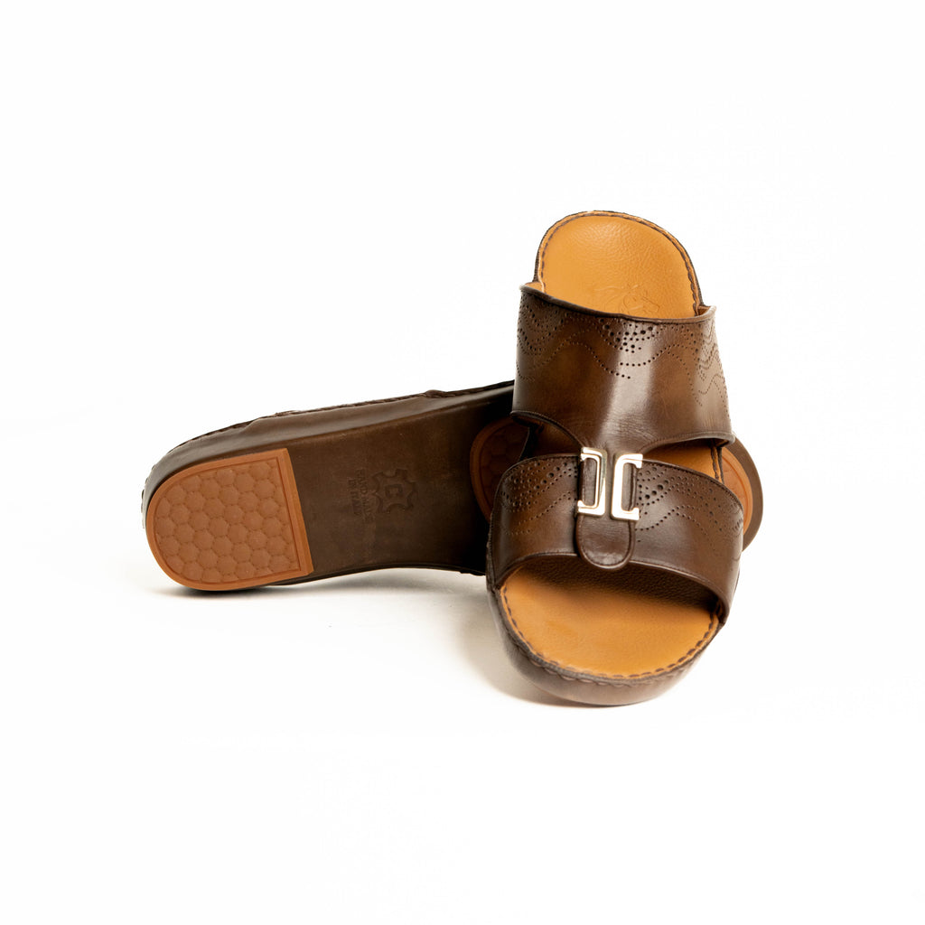 Brown leather sandals with a gold buckle on a white background