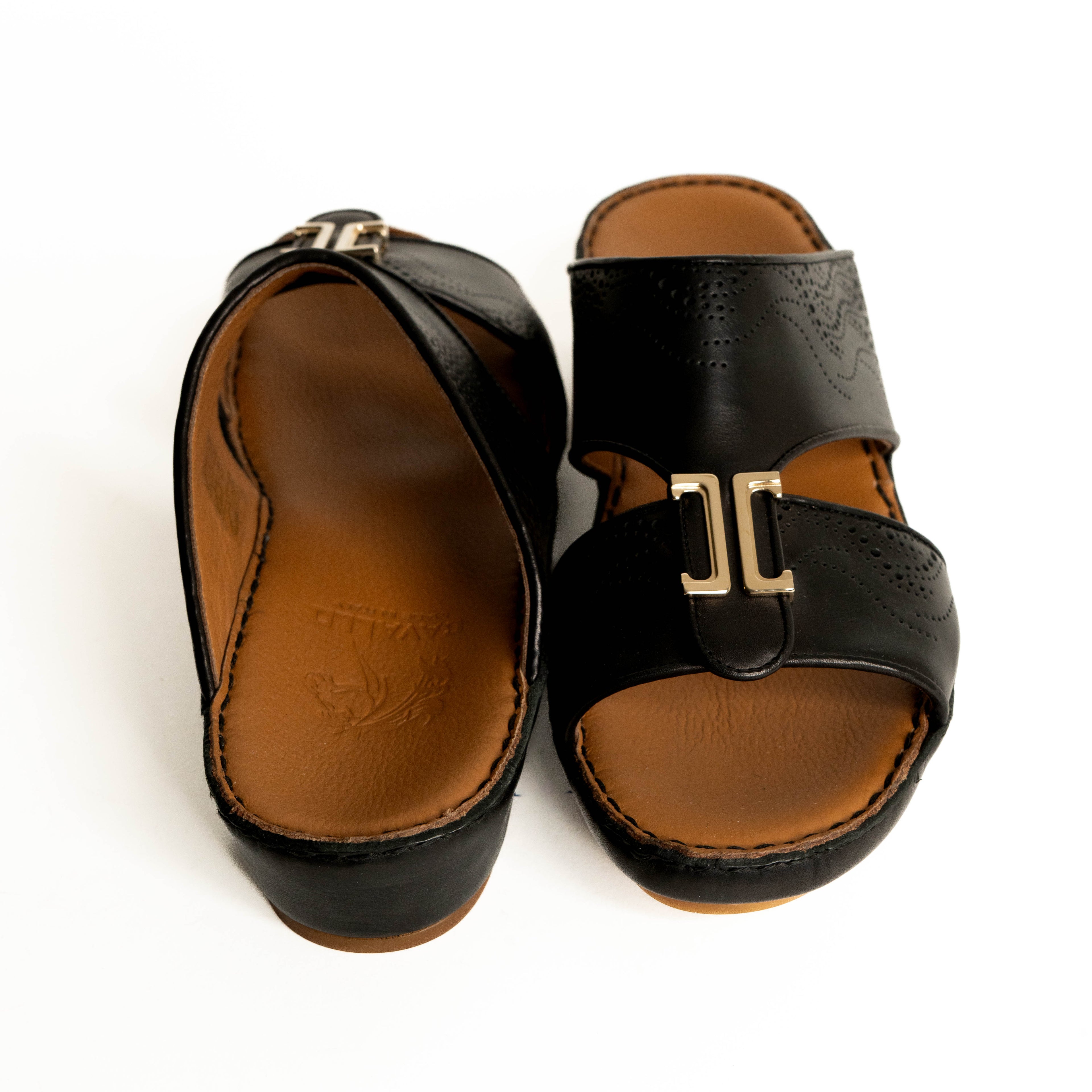 Black sandals with brown soles on a white background