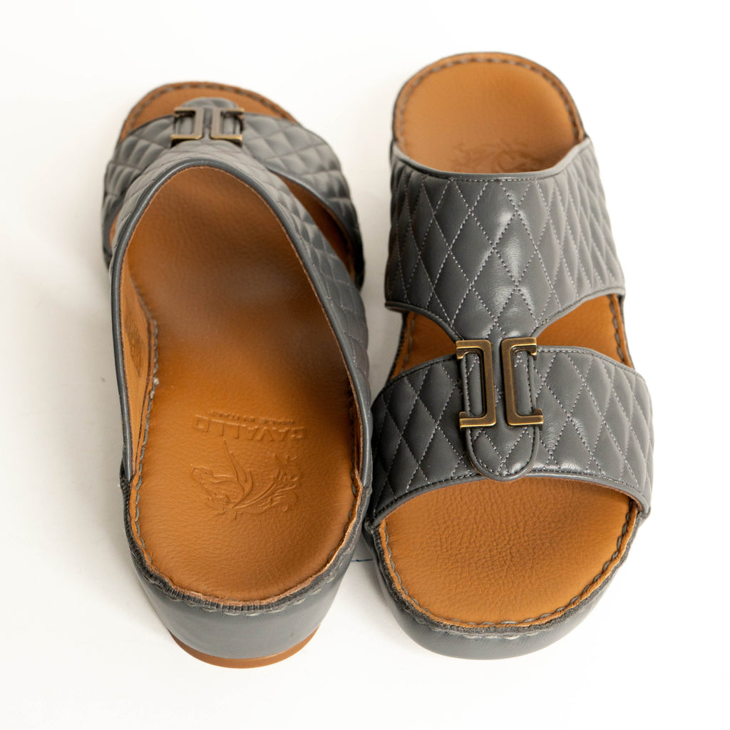 Pair of gray sandals with brown soles on a white background