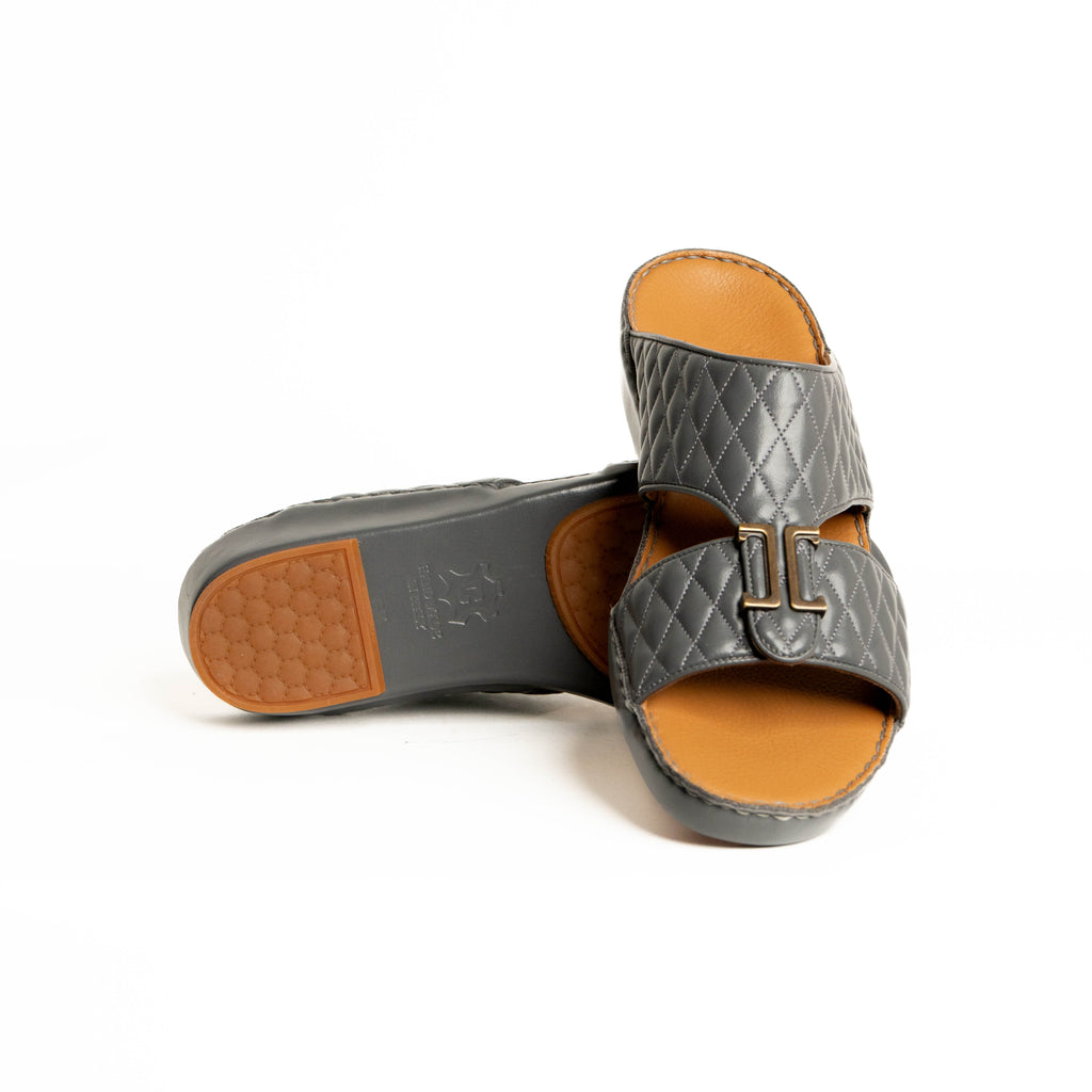 Gray quilted sandal with tan interior and sole on a white background