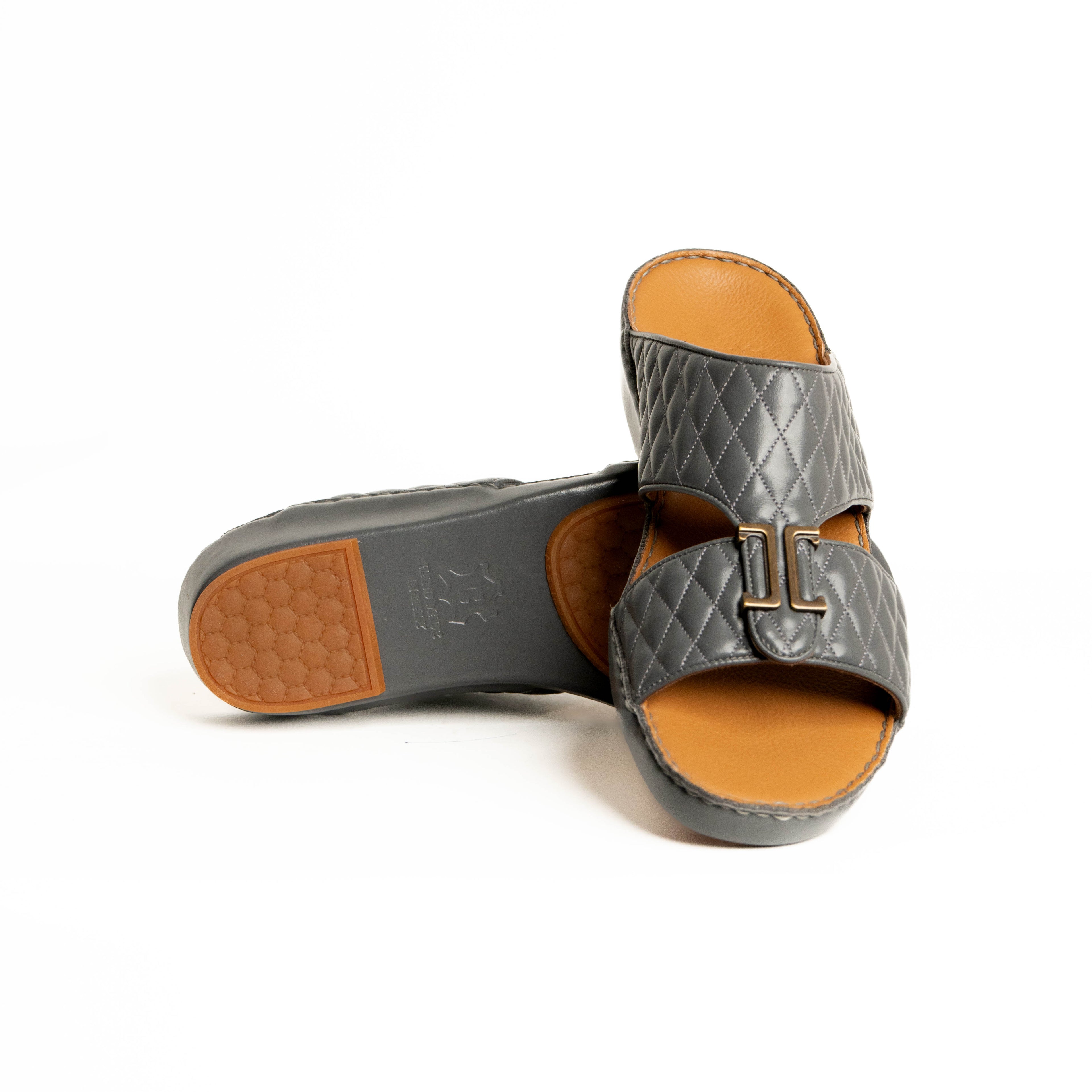 Gray quilted sandal with tan interior and sole on a white background
