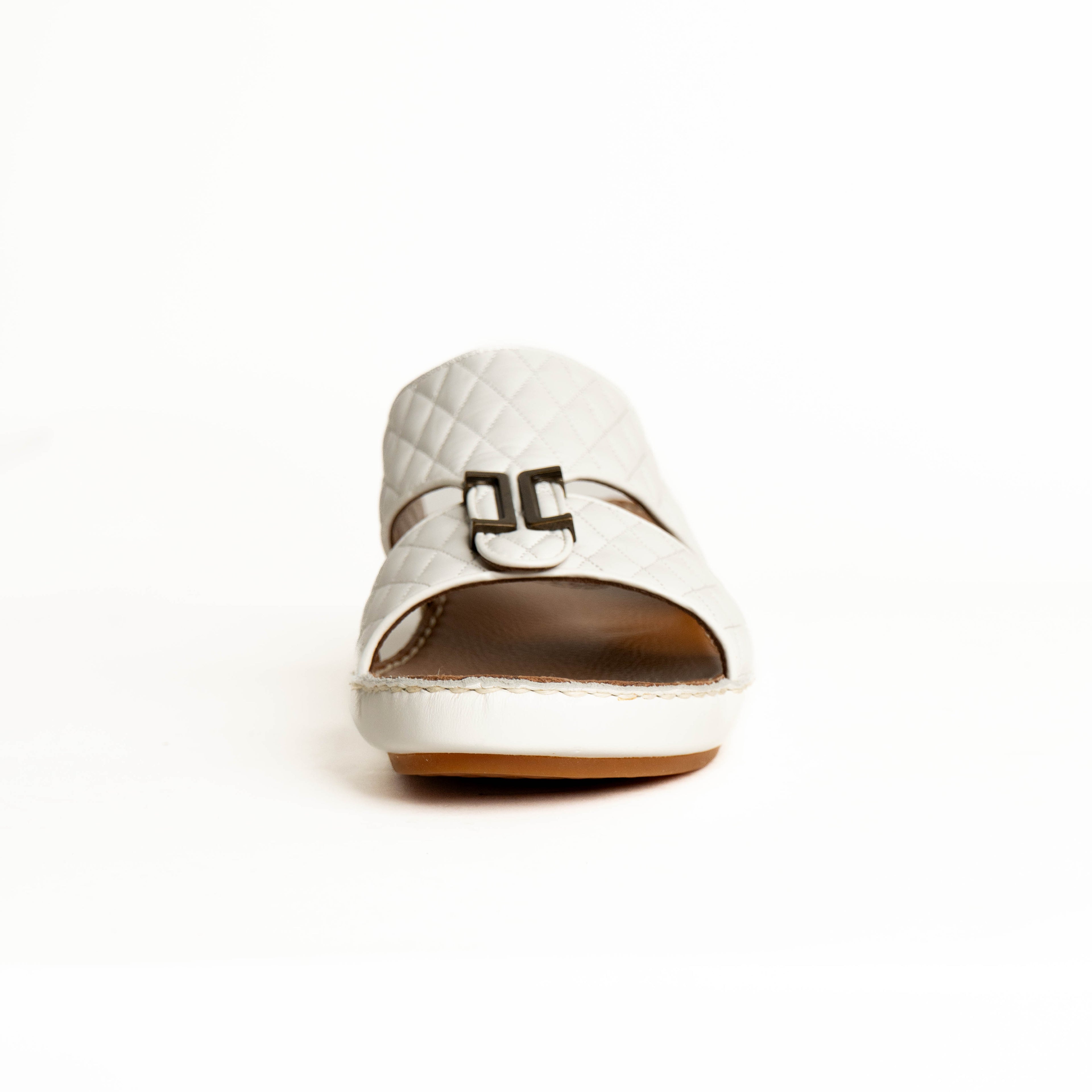 White shoe with a brown sole on a white background