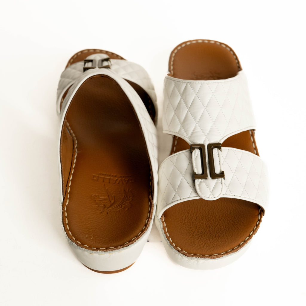 White sandals with brown soles on a white background