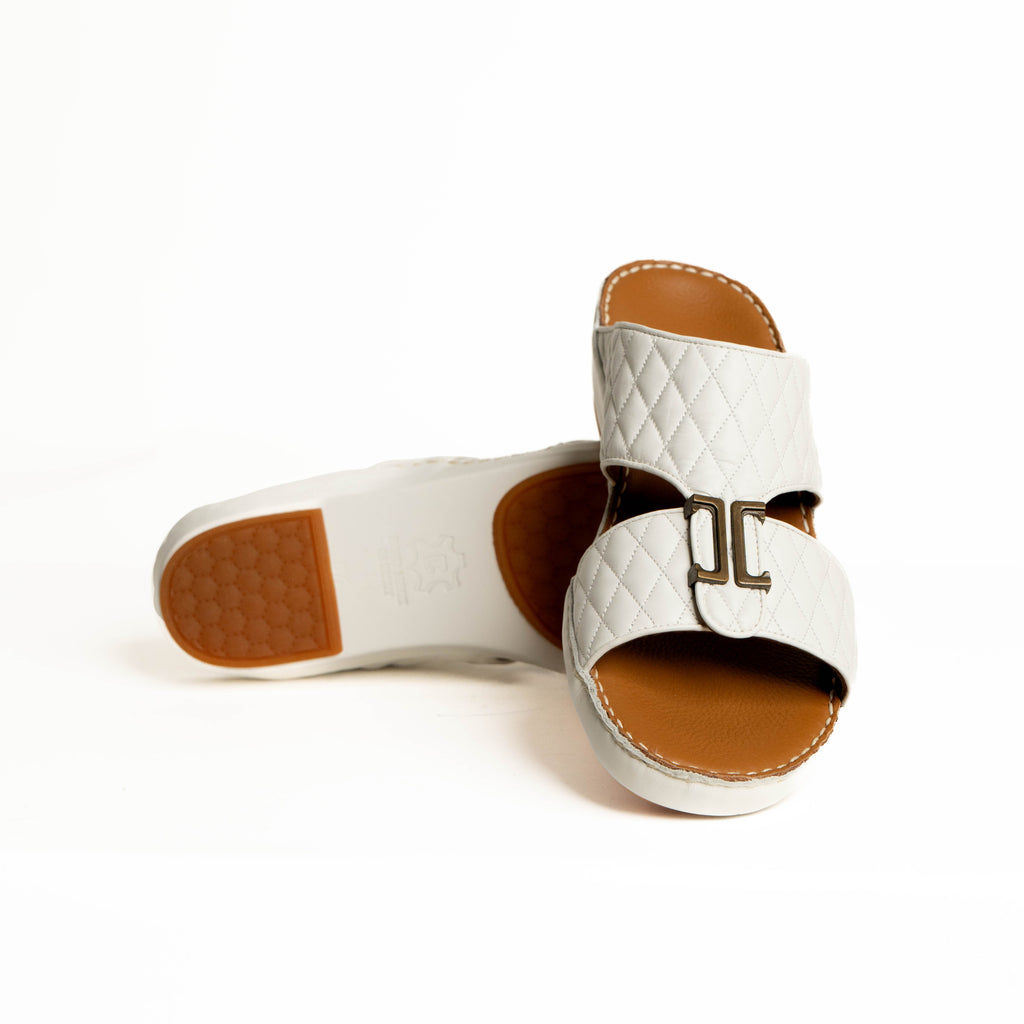 White sandals with brown soles on a white background