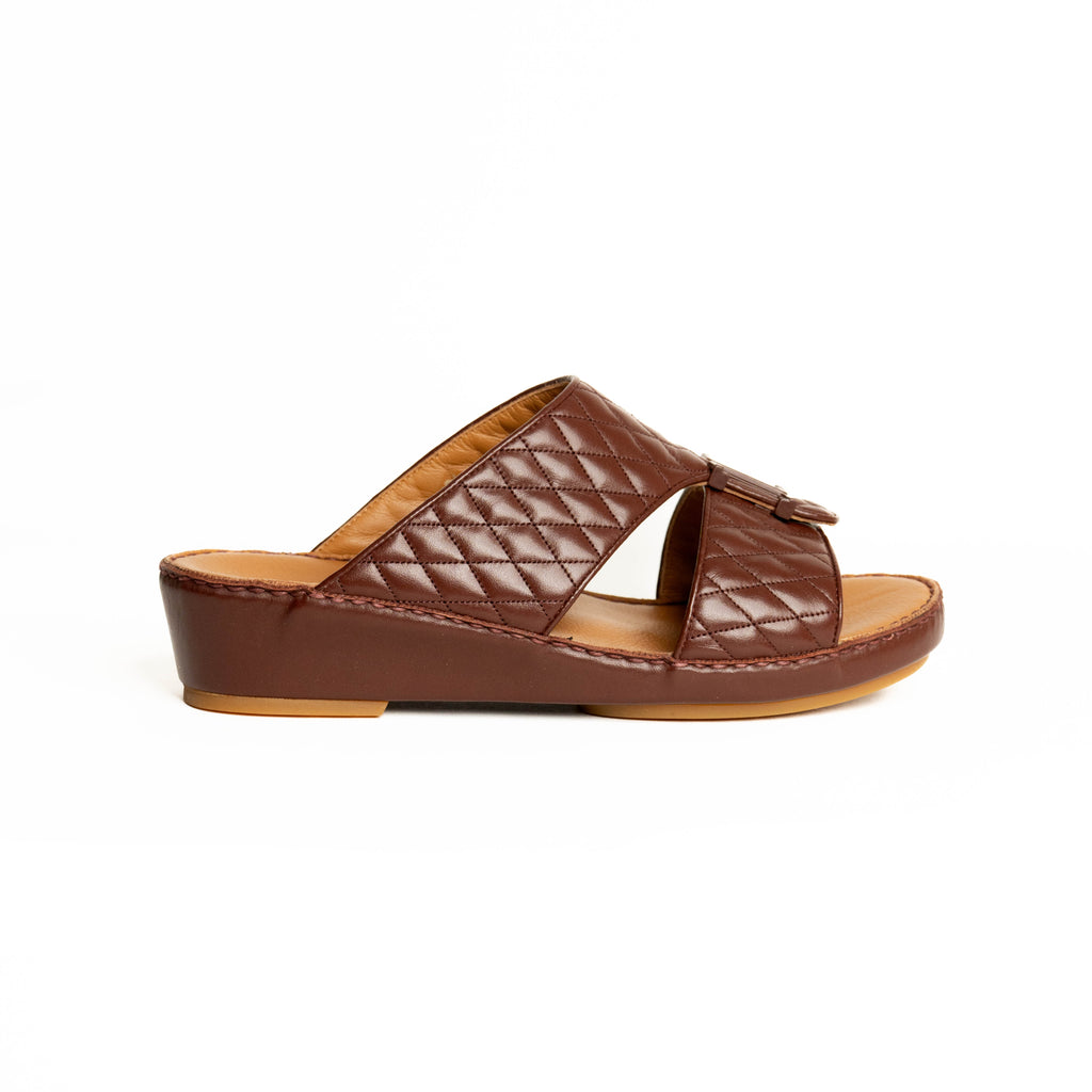 Brown quilted sandal on a white background