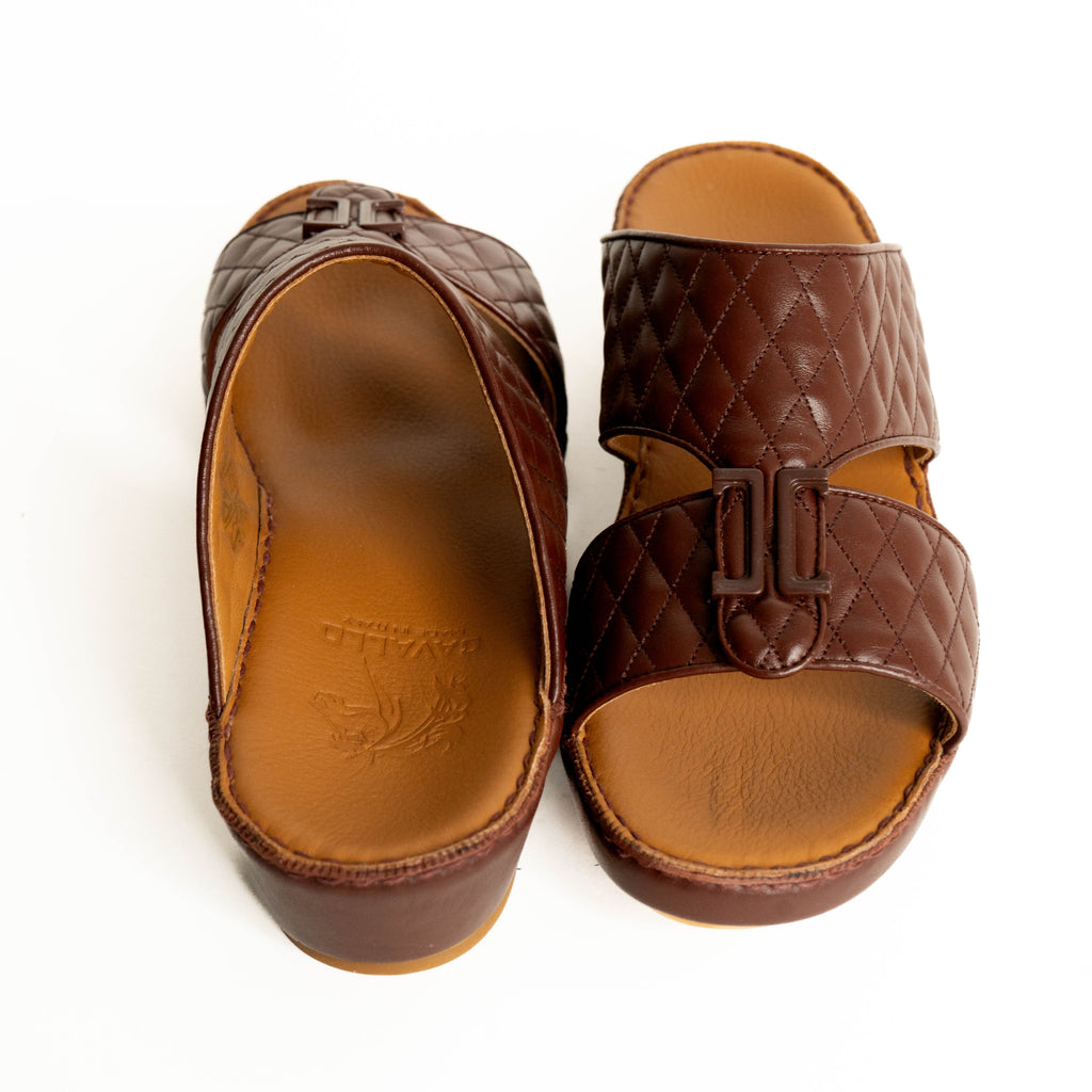 Pair of brown quilted sandals on a white background