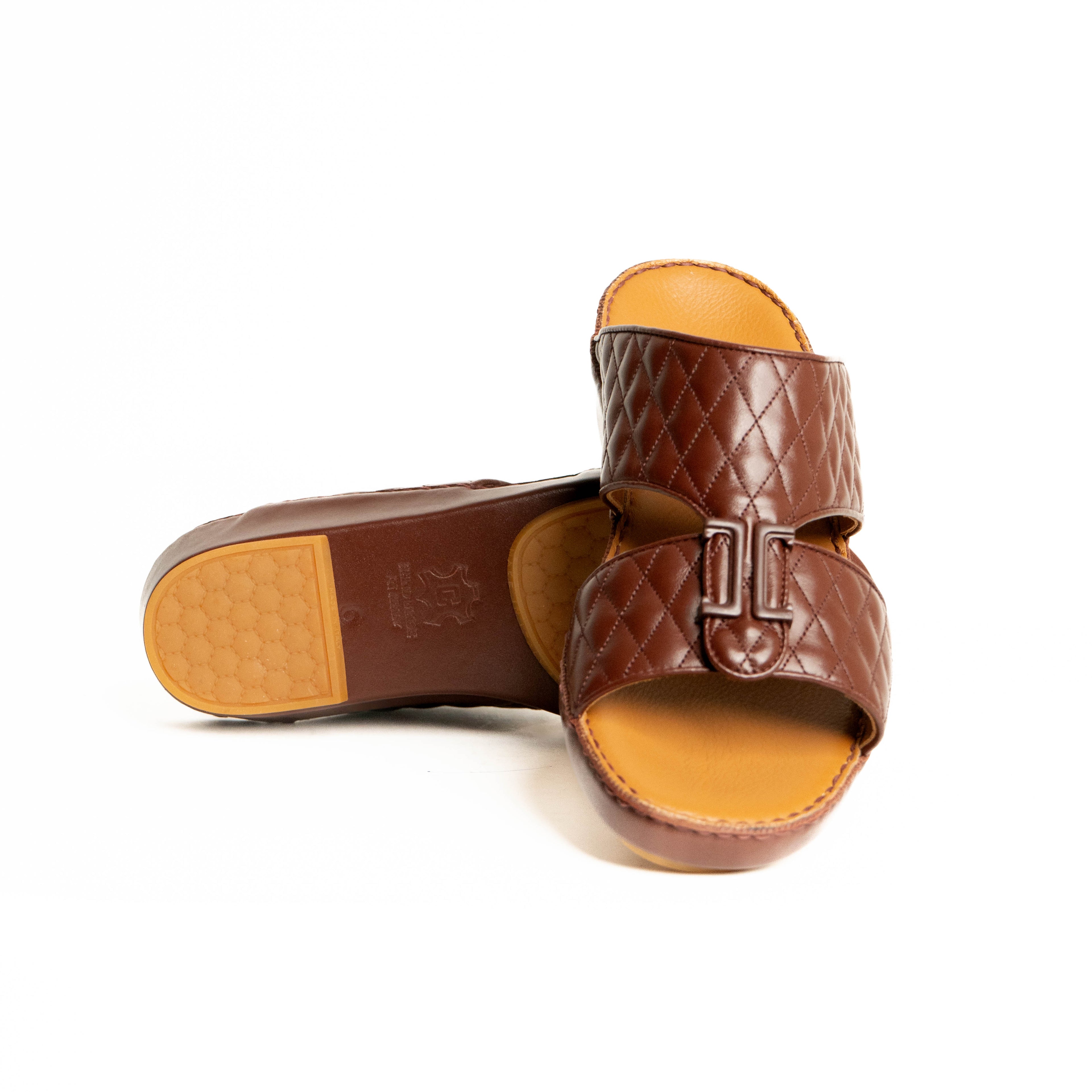 Brown quilted sandal with tan insole on a white background