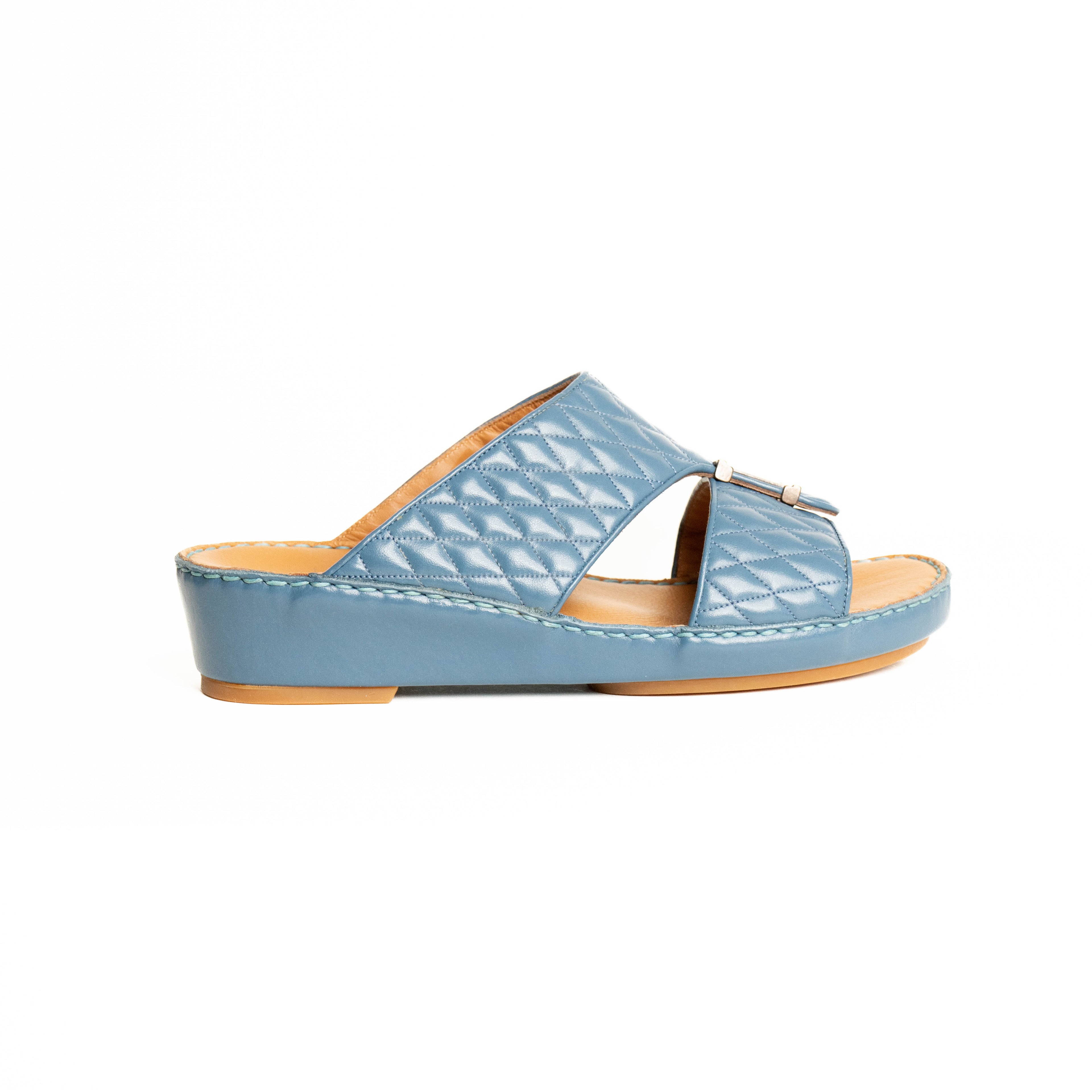 Blue sandal with a brown sole on a white background