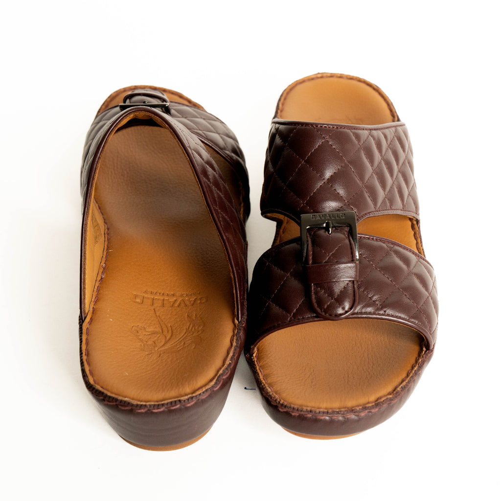 Pair of brown sandals with a buckle on a white background