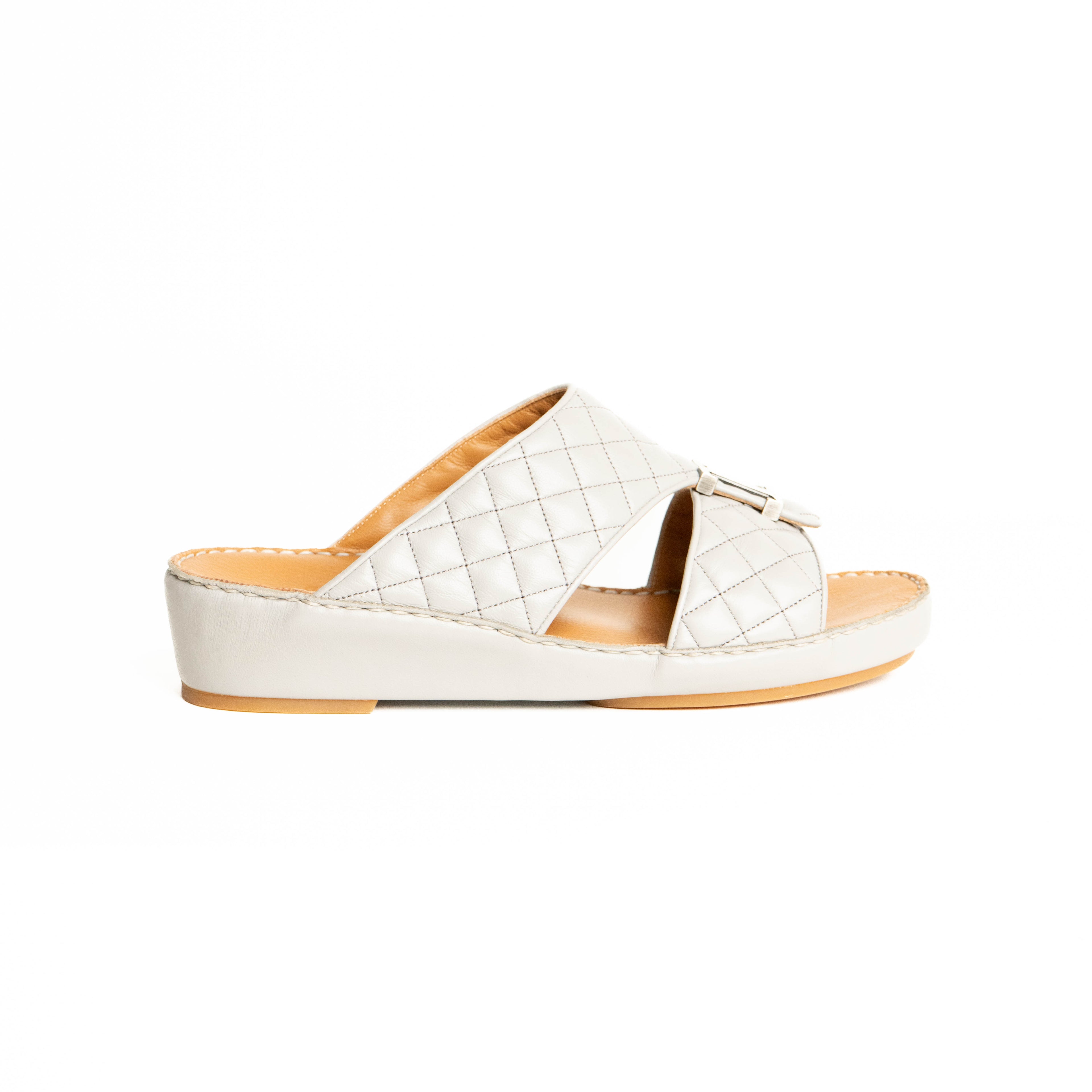 White woven sandal with a brown sole on a white background