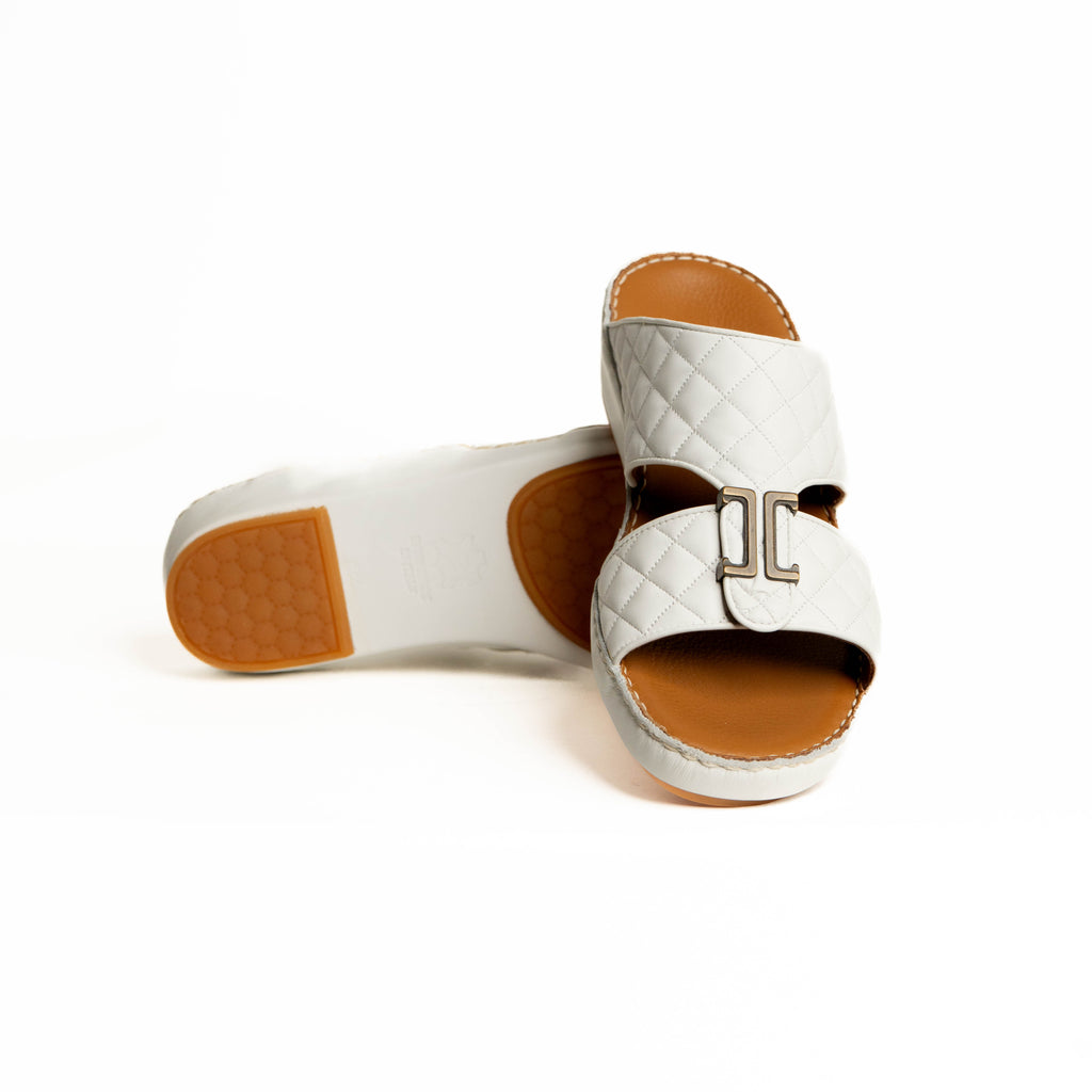 White sandals with brown soles on a white background