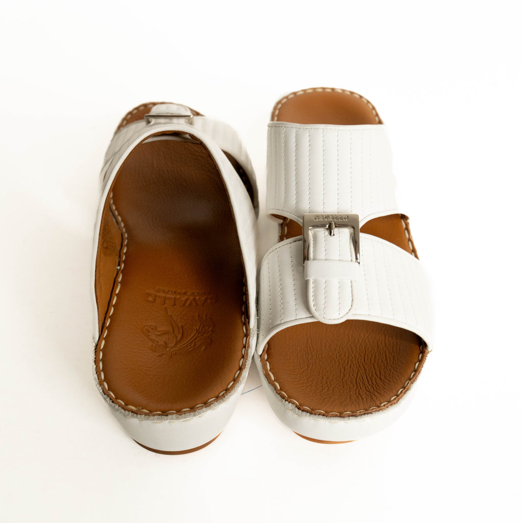 White sandals with brown soles on a white background