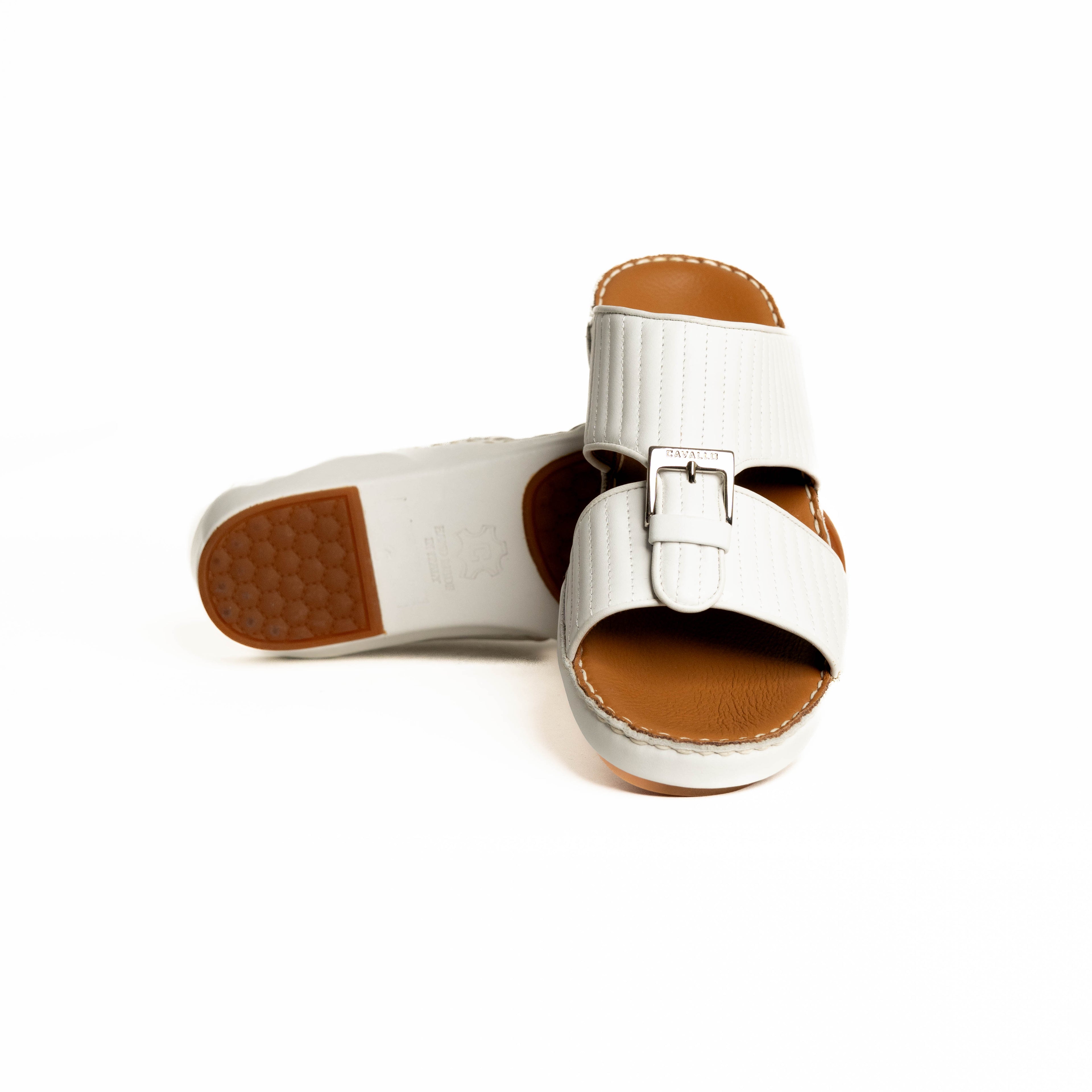 White sandal with brown sole on a white background