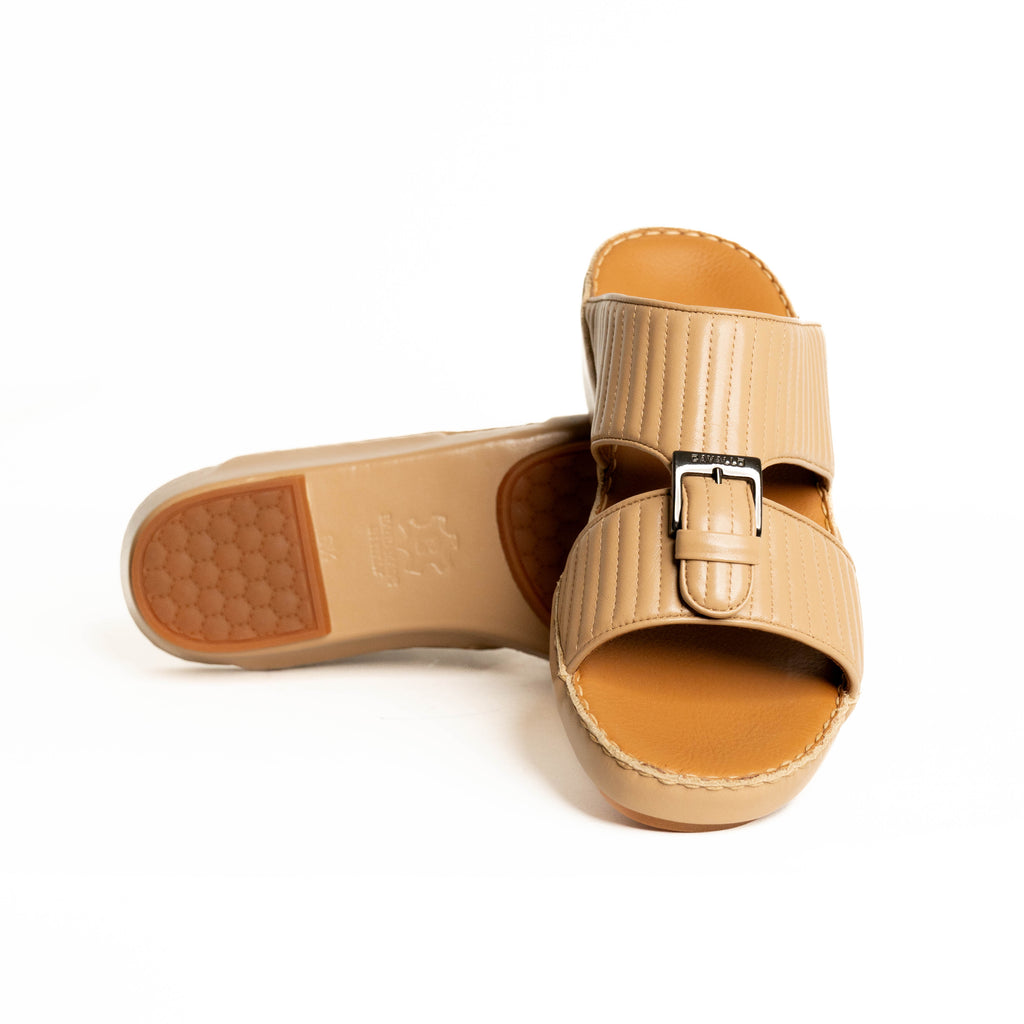 Beige sandal with a buckle on a white background