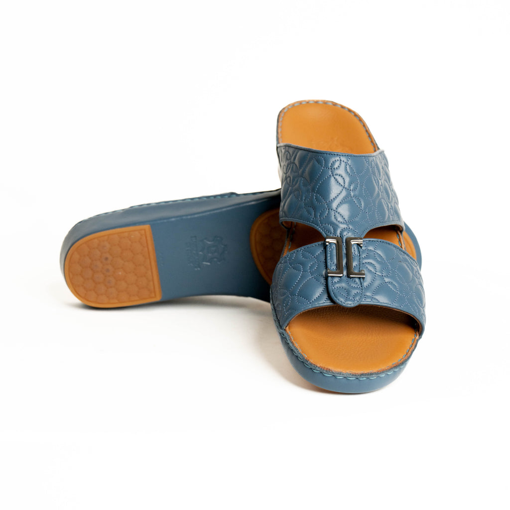 Blue sandals with brown soles on a white background