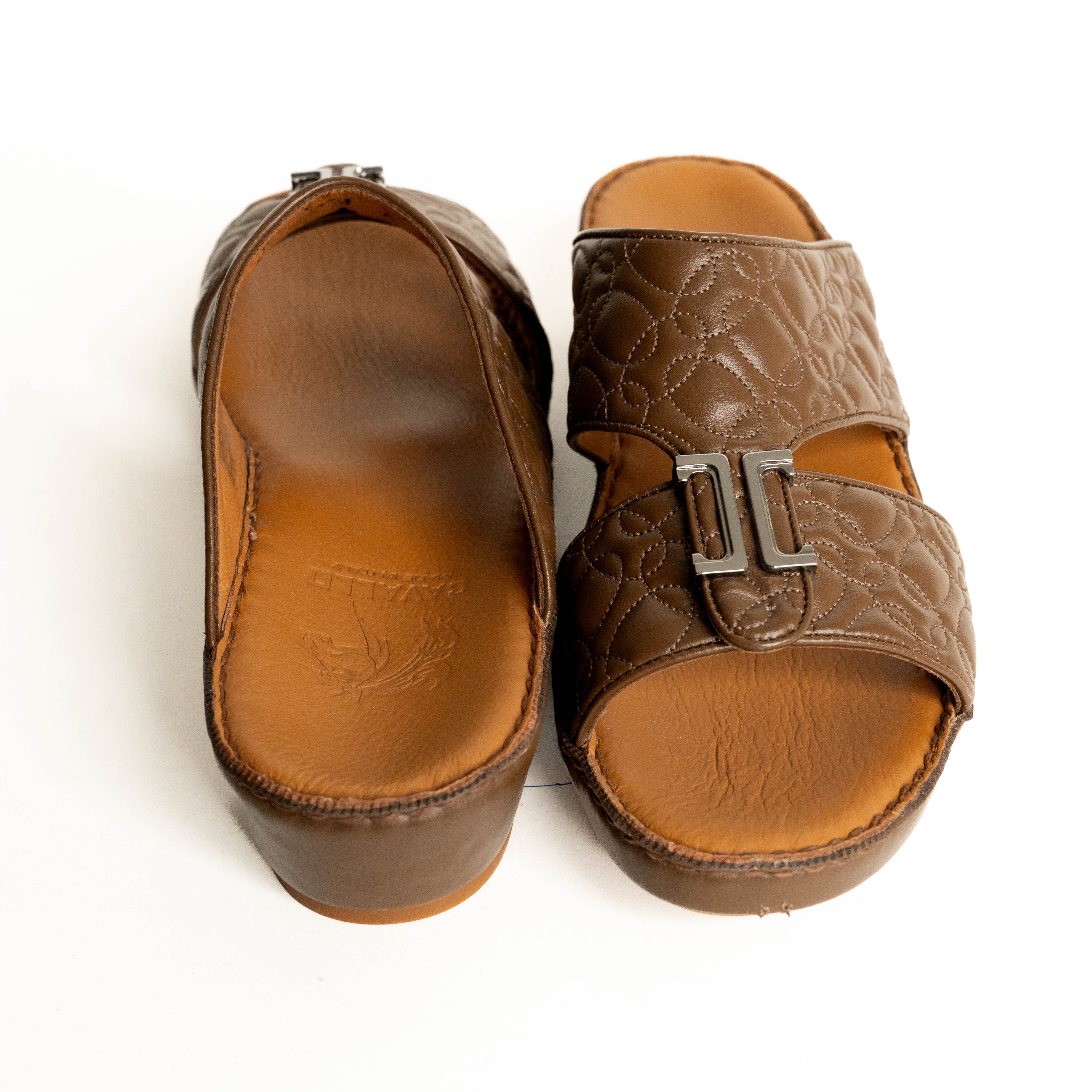 Pair of brown sandals with a buckle on a white background