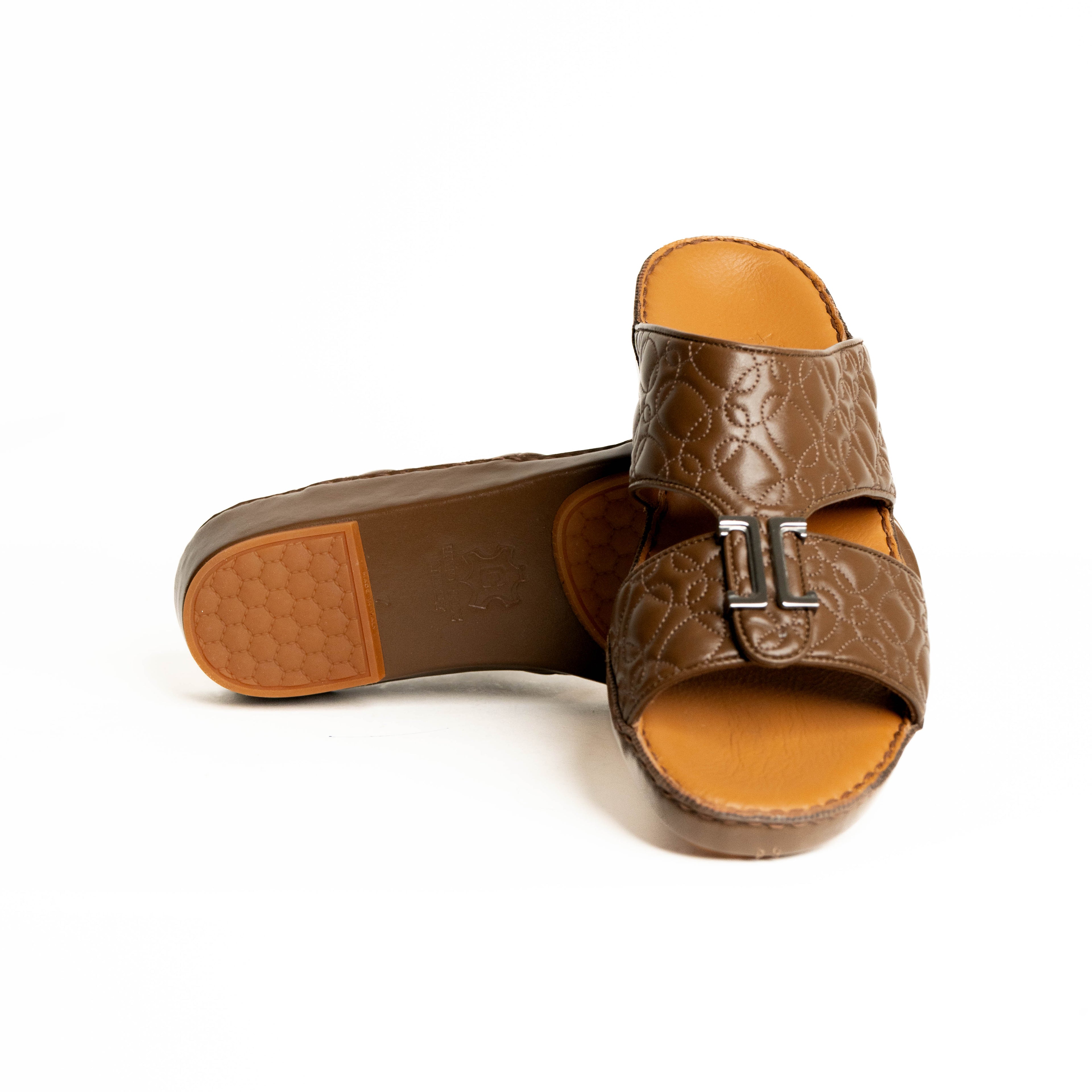 Brown sandal with a buckle on a white background