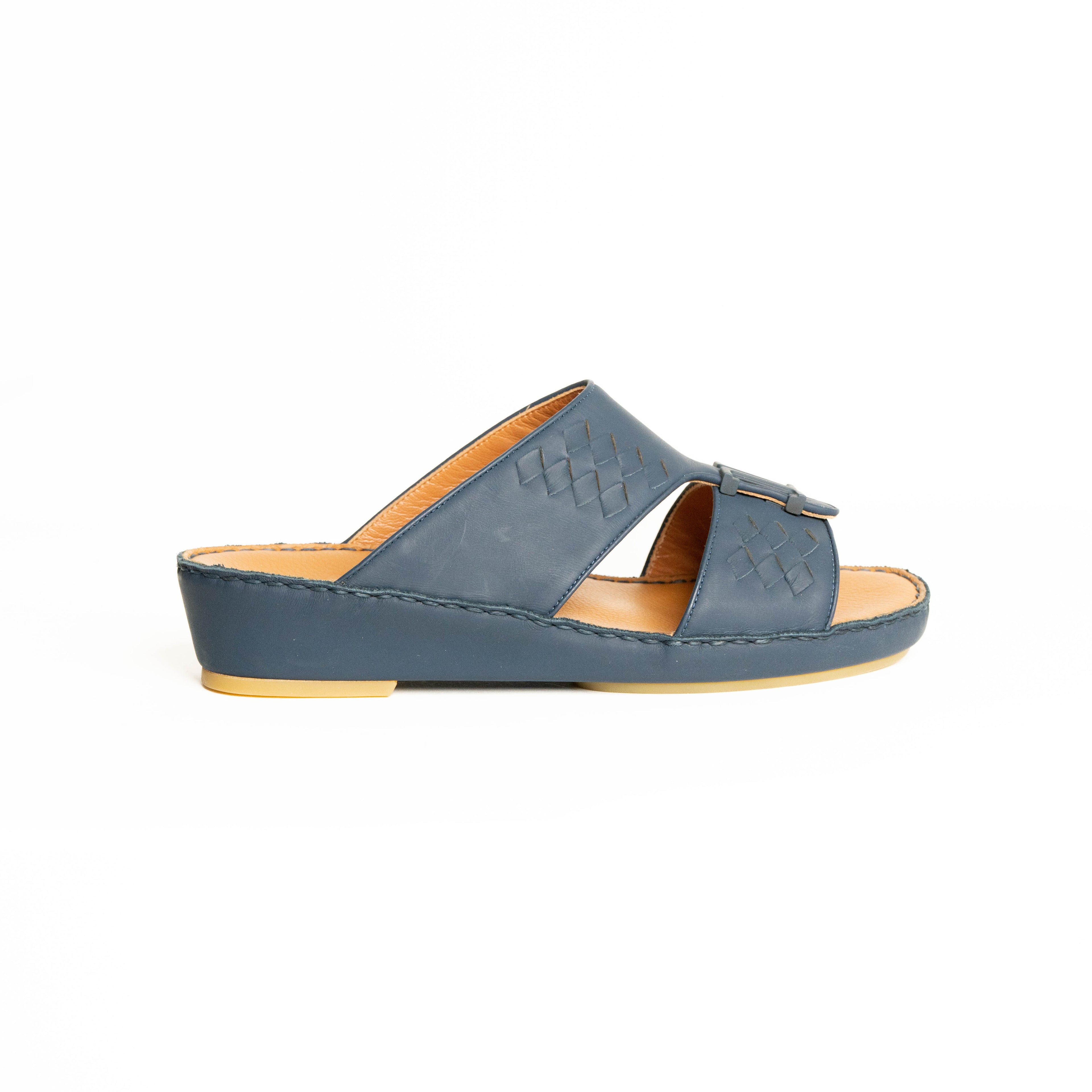 Blue sandal with a tan insole on a white background