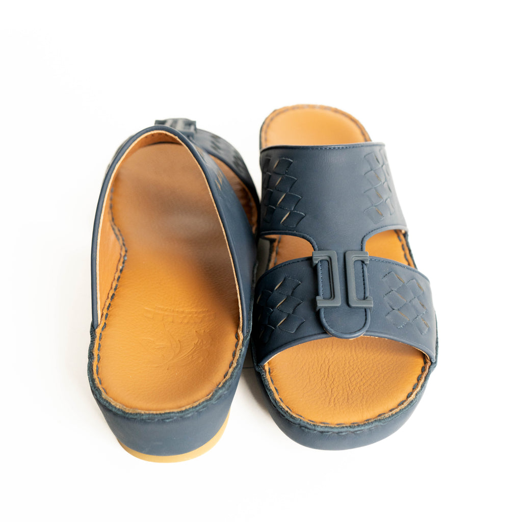 Pair of blue sandals with tan soles on a white background