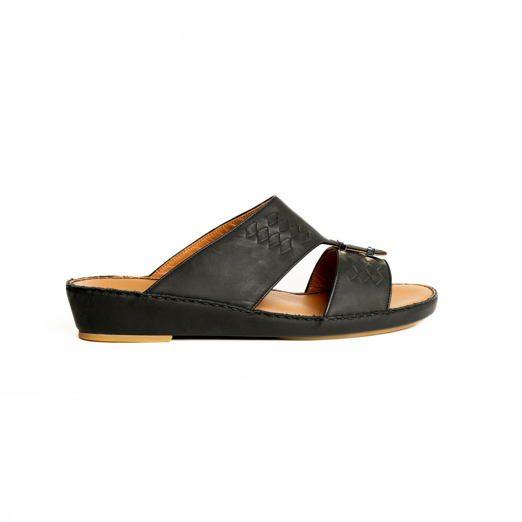Black sandal with a woven pattern on a white background