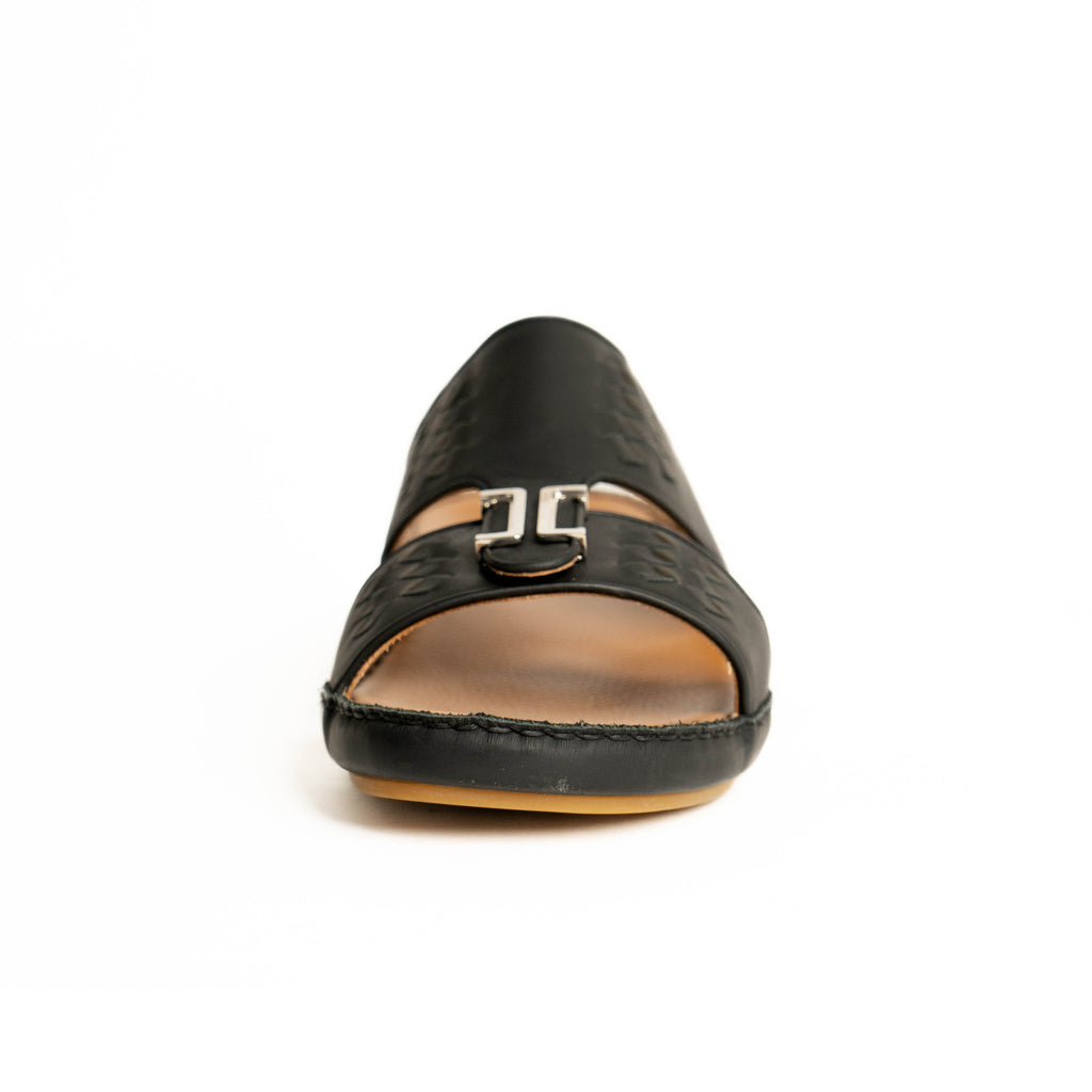 Black sandal with a brown sole on a white background