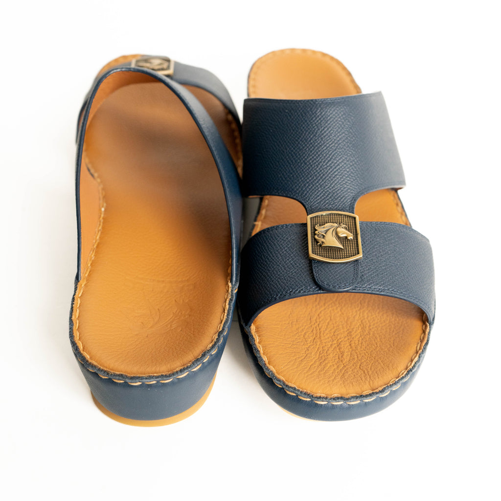 Pair of blue sandals with brown soles on a white background