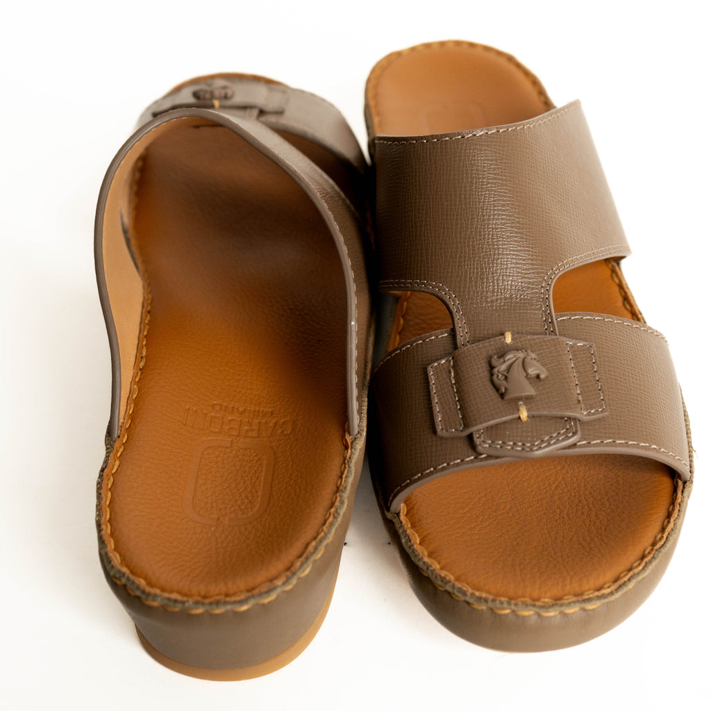 Pair of brown sandals with a visible brand logo on a white background