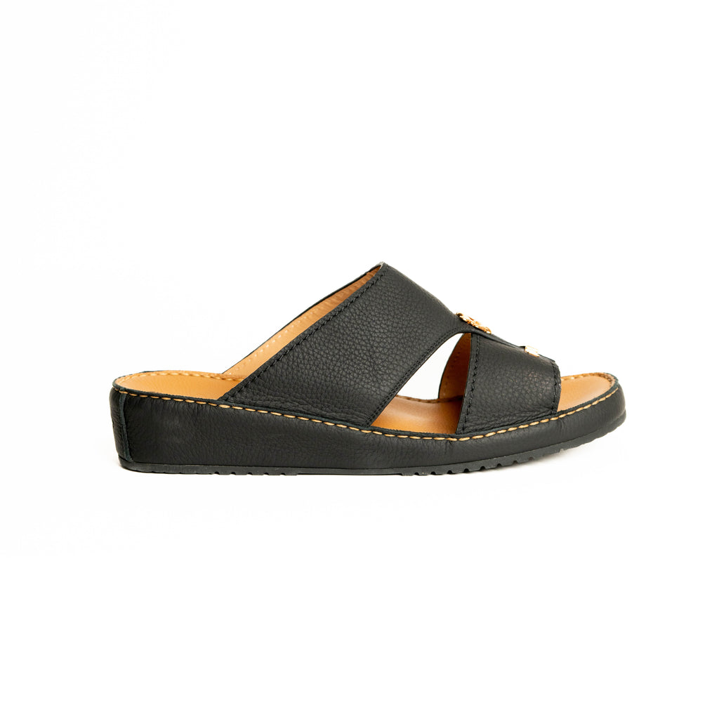 Black sandal with tan interior on a white background
