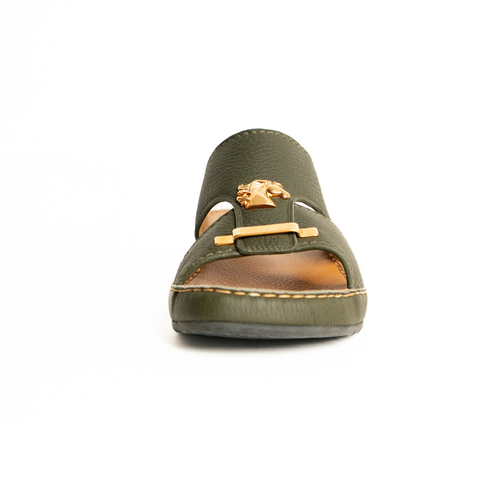 Green sandal with a decorative buckle on a white background