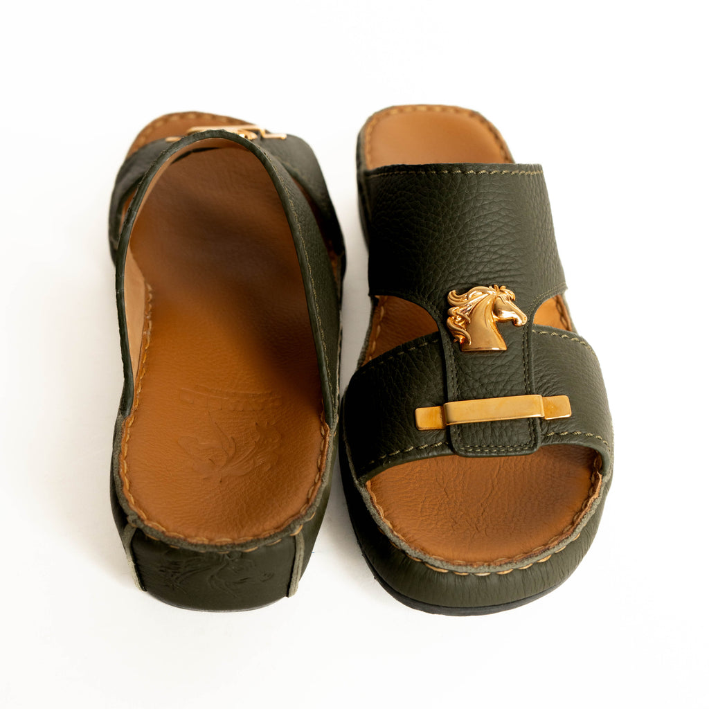 Pair of green sandals with brown soles on a white background