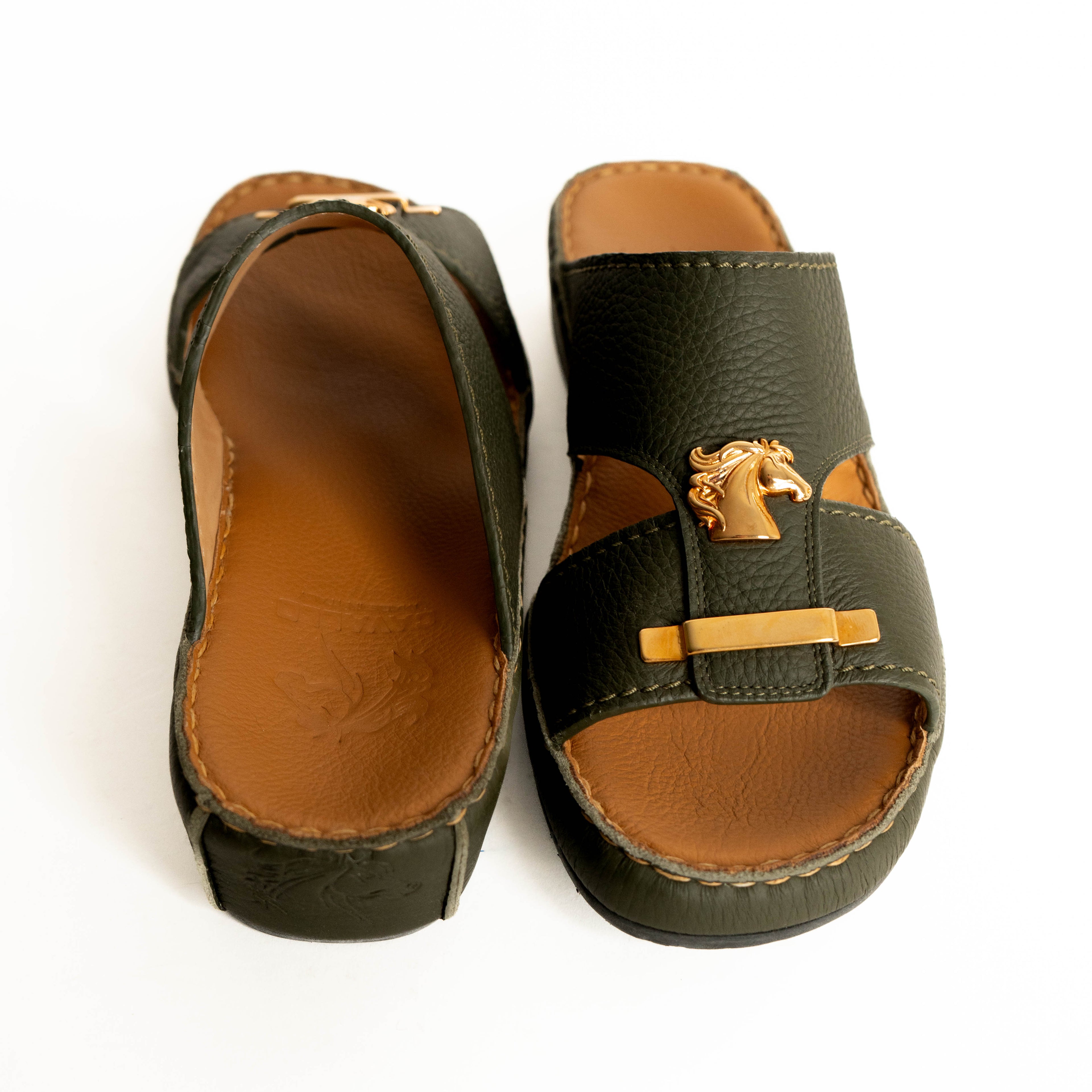 Pair of green sandals with brown soles on a white background