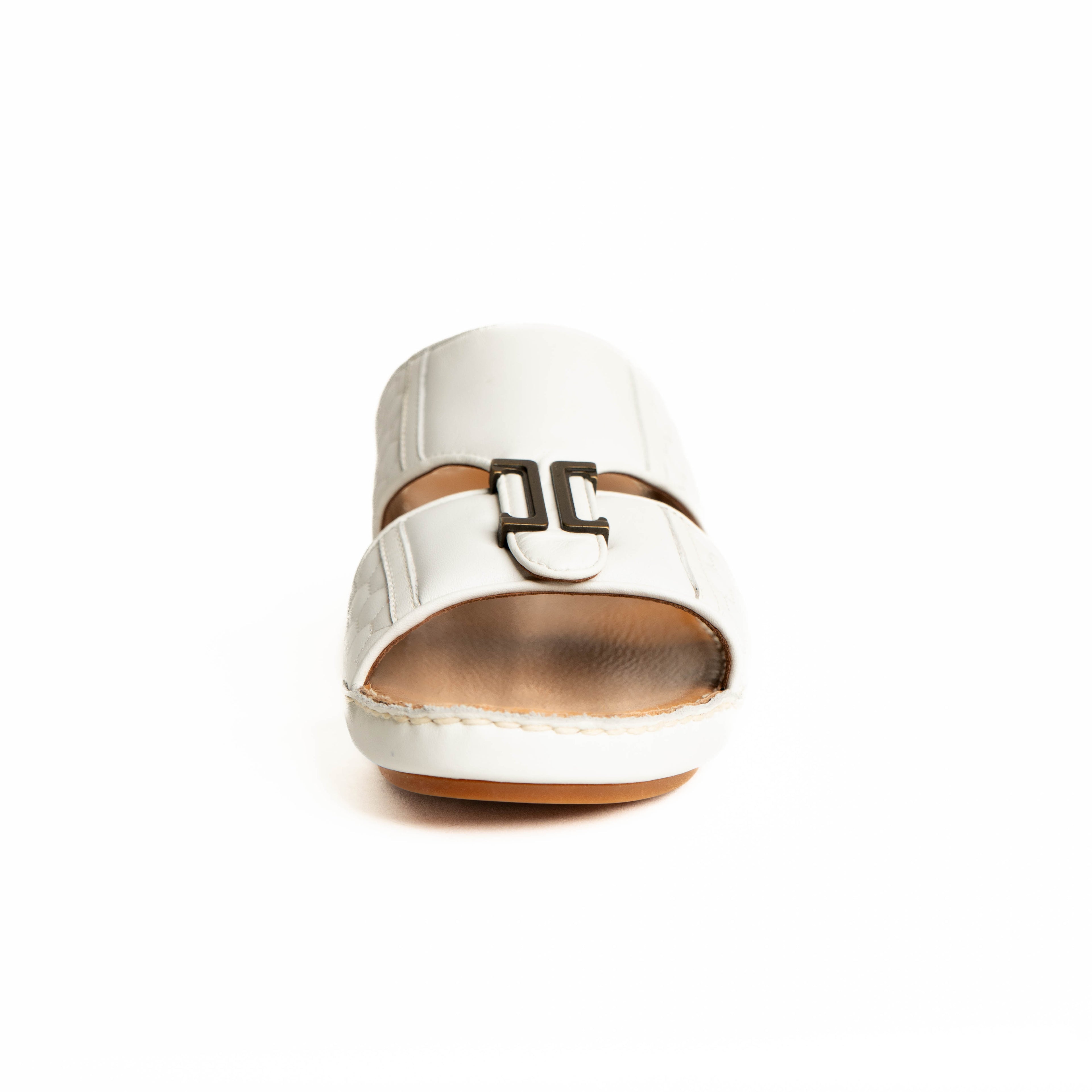 White sandal with a brown sole on a white background