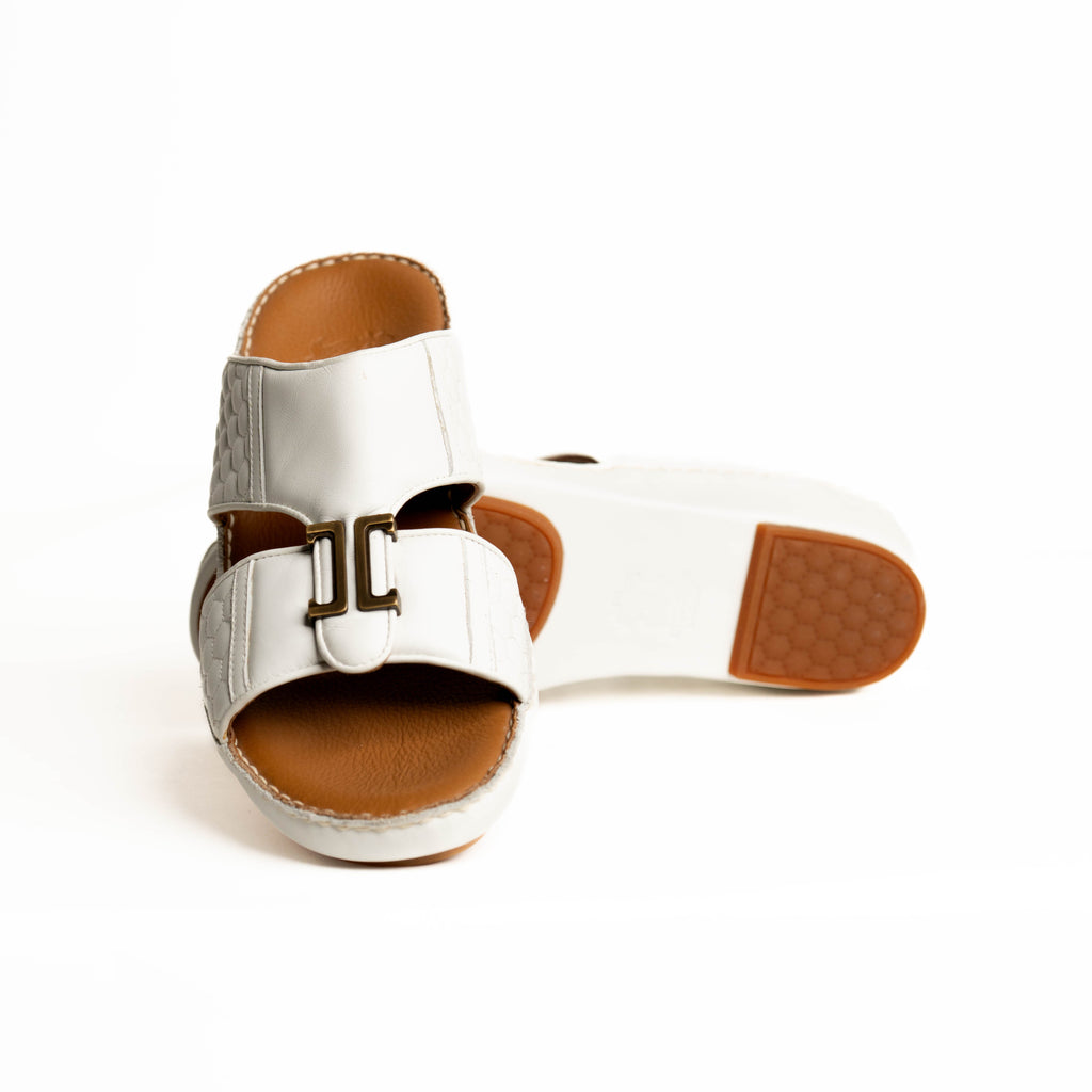 Silver sandal with brown sole on a white background