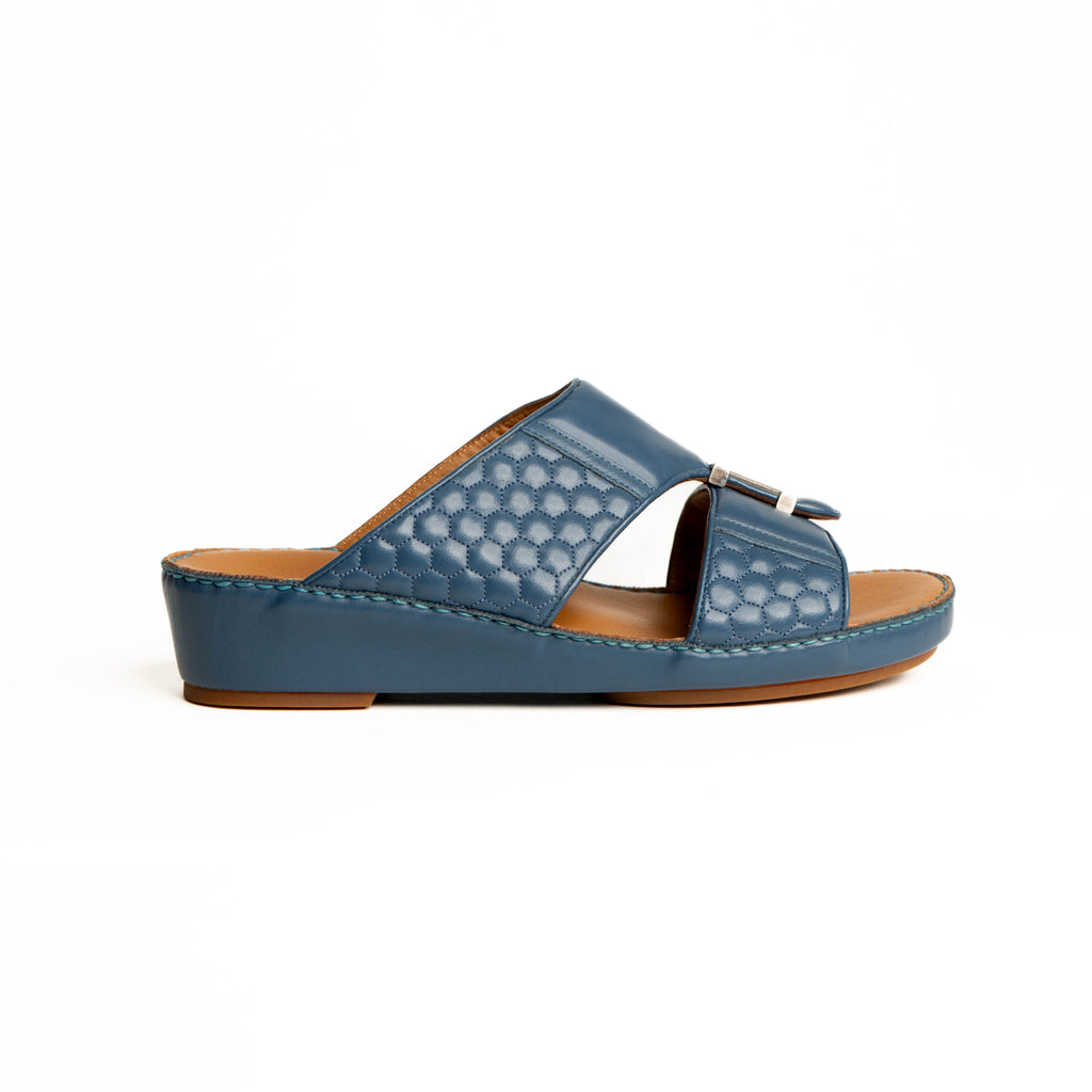 Blue sandal with a brown sole on a white background
