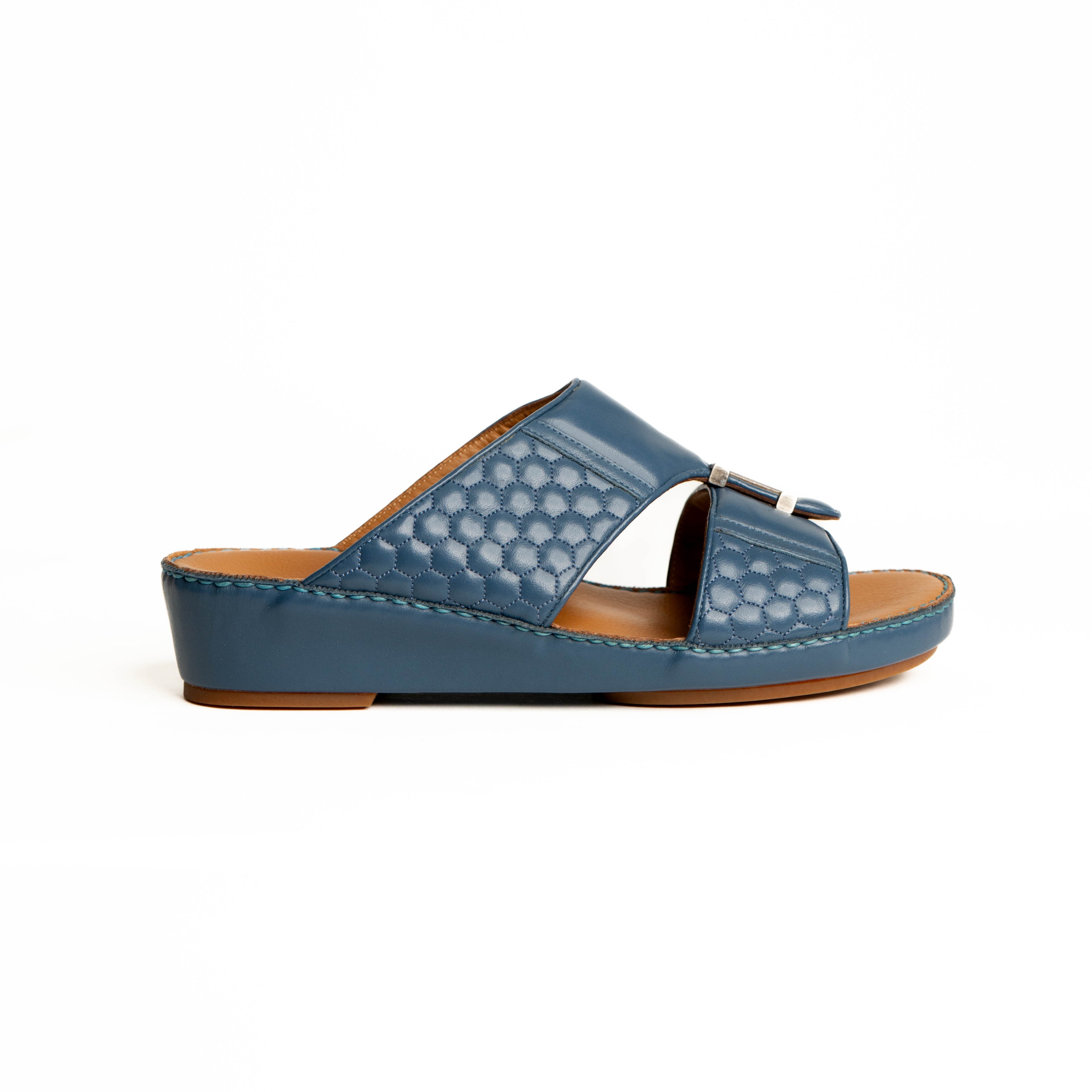 Blue sandal with a brown sole on a white background