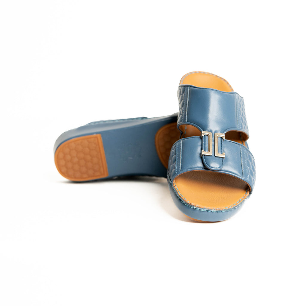 Blue sandals with brown soles on a white background