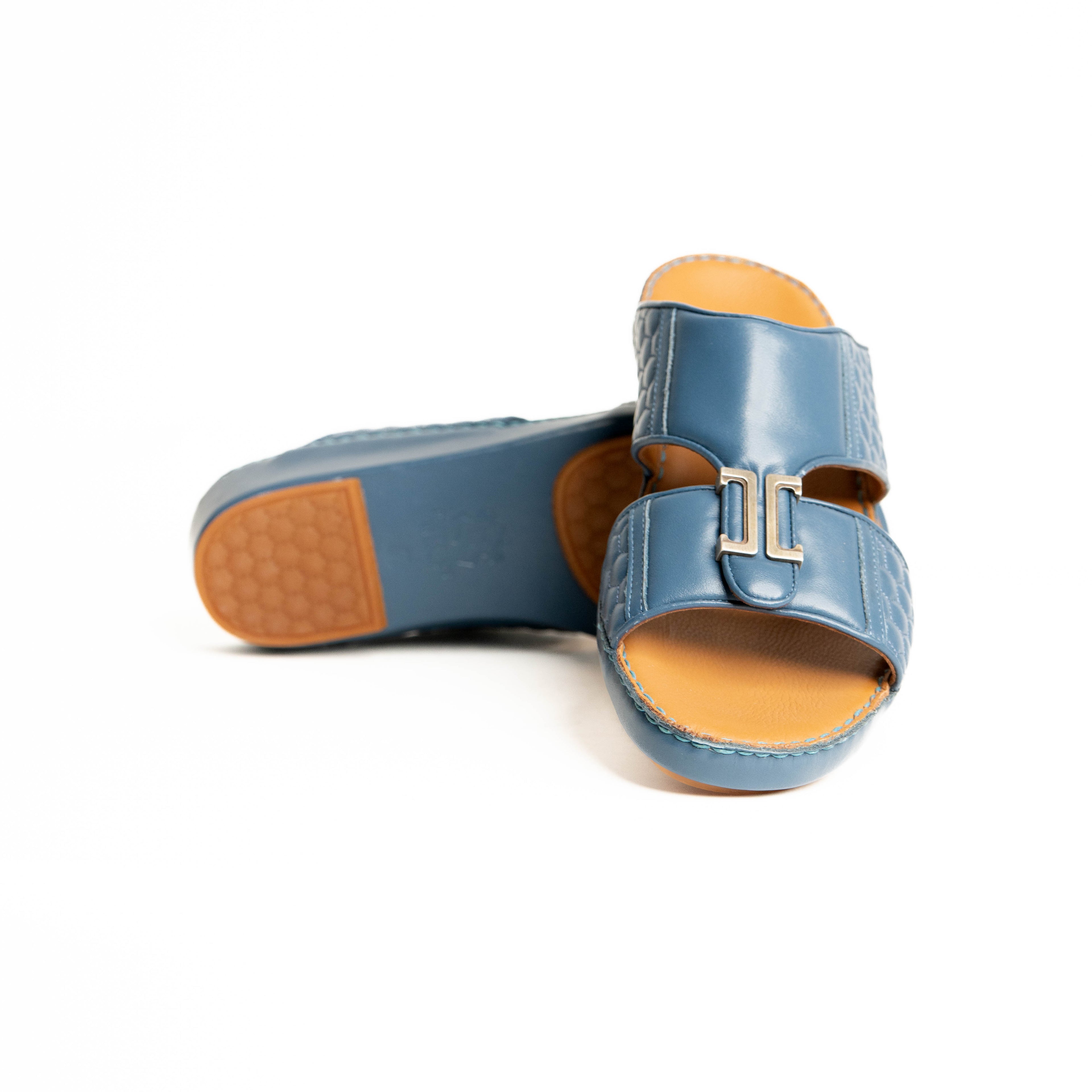 Blue sandals with brown soles on a white background