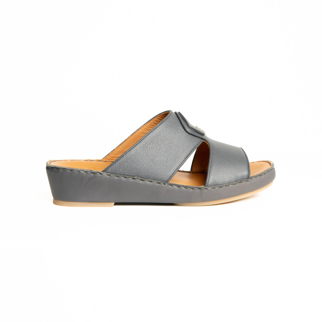 Gray sandal with a tan sole on a white background