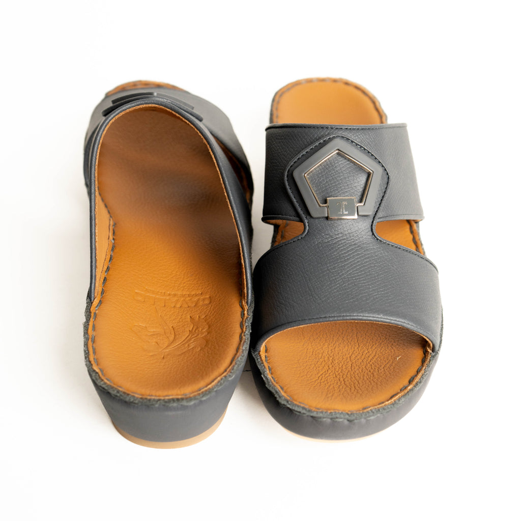 Pair of gray sandals with brown soles on a white background