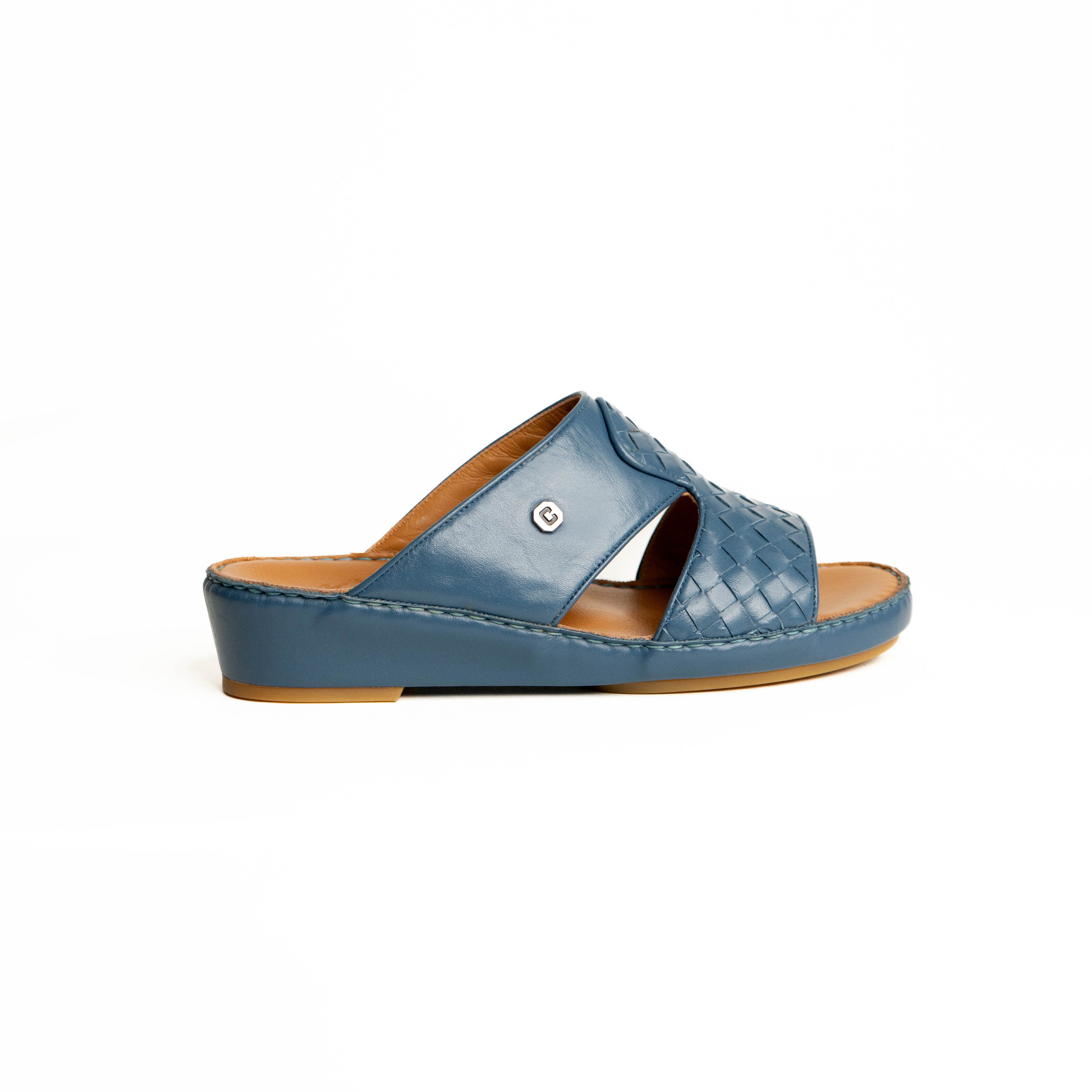 Blue sandal with a brown sole on a white background