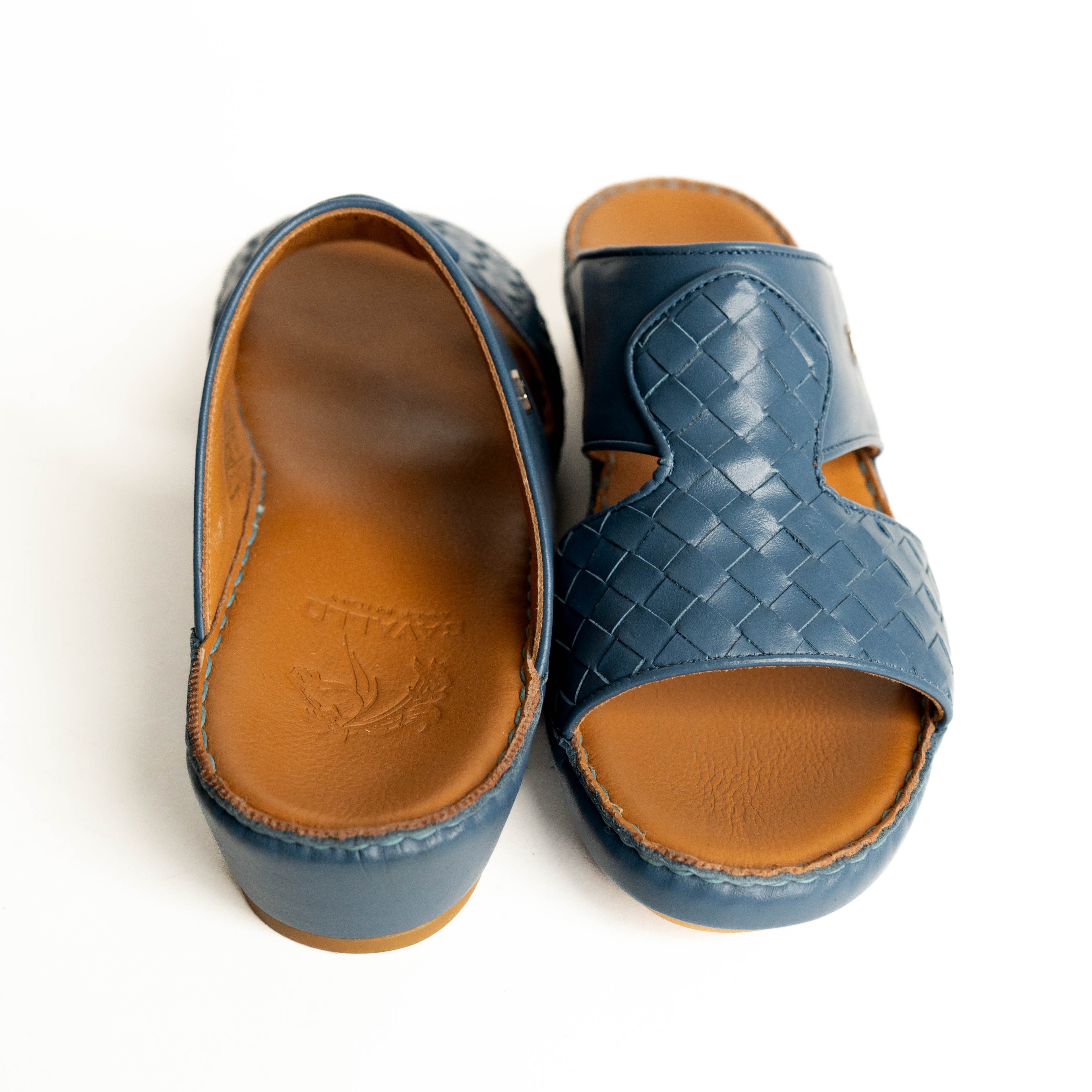 Blue woven sandals with brown soles on a white background